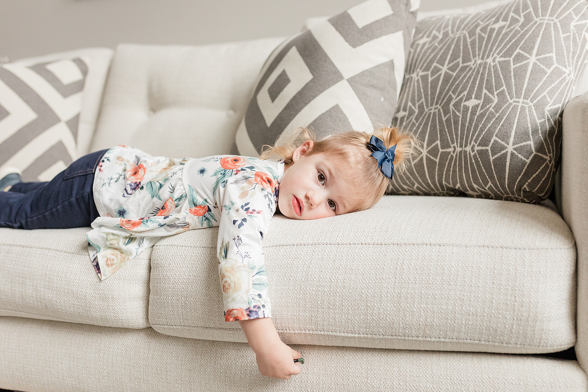 toddler lays on couch during Columbia MD family portraits