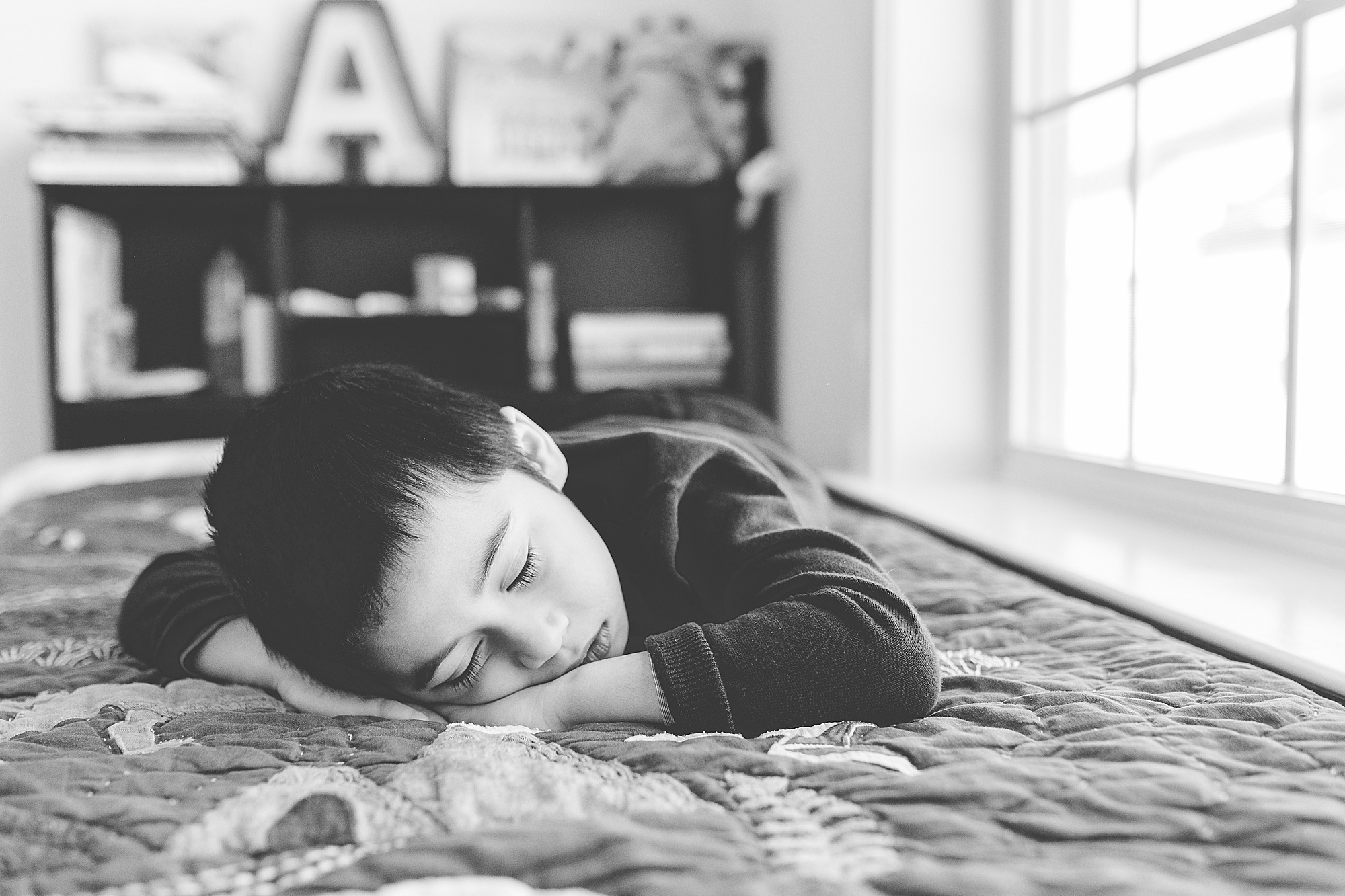 boy sleeps on bed during Silver Spring lifestyle family session