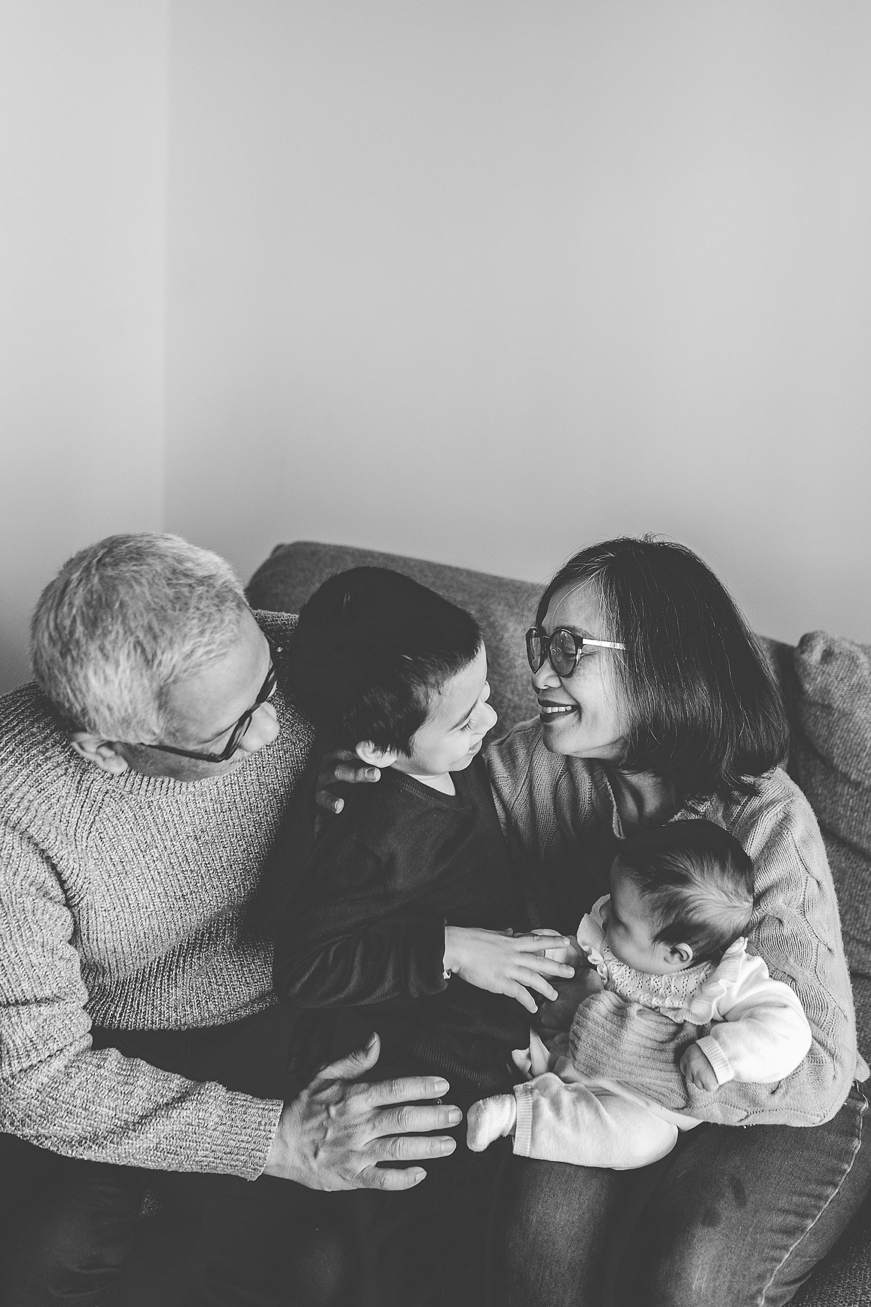 grandparents laugh with grandchildren in home