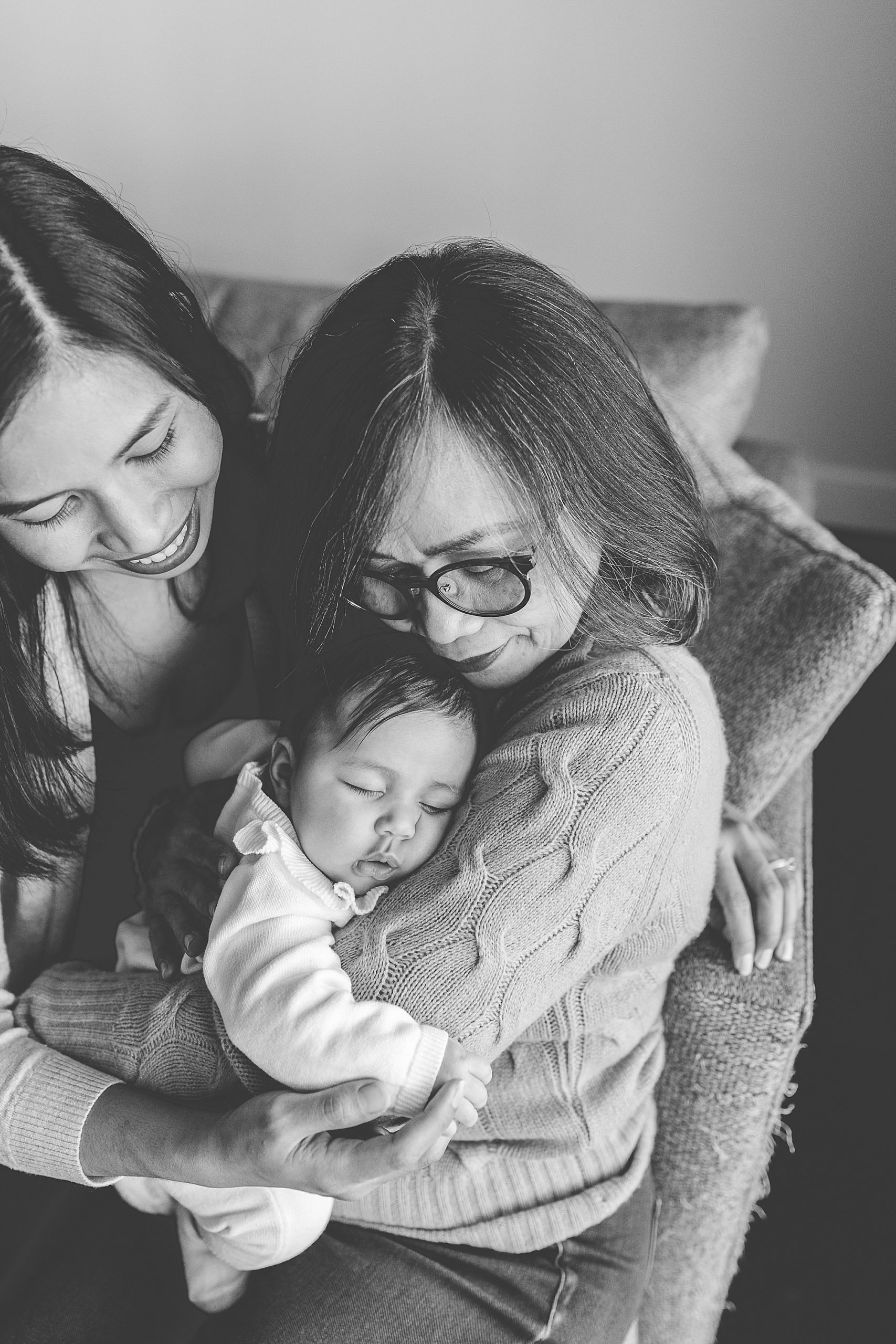 grandmother holds baby during family photos with daughter 