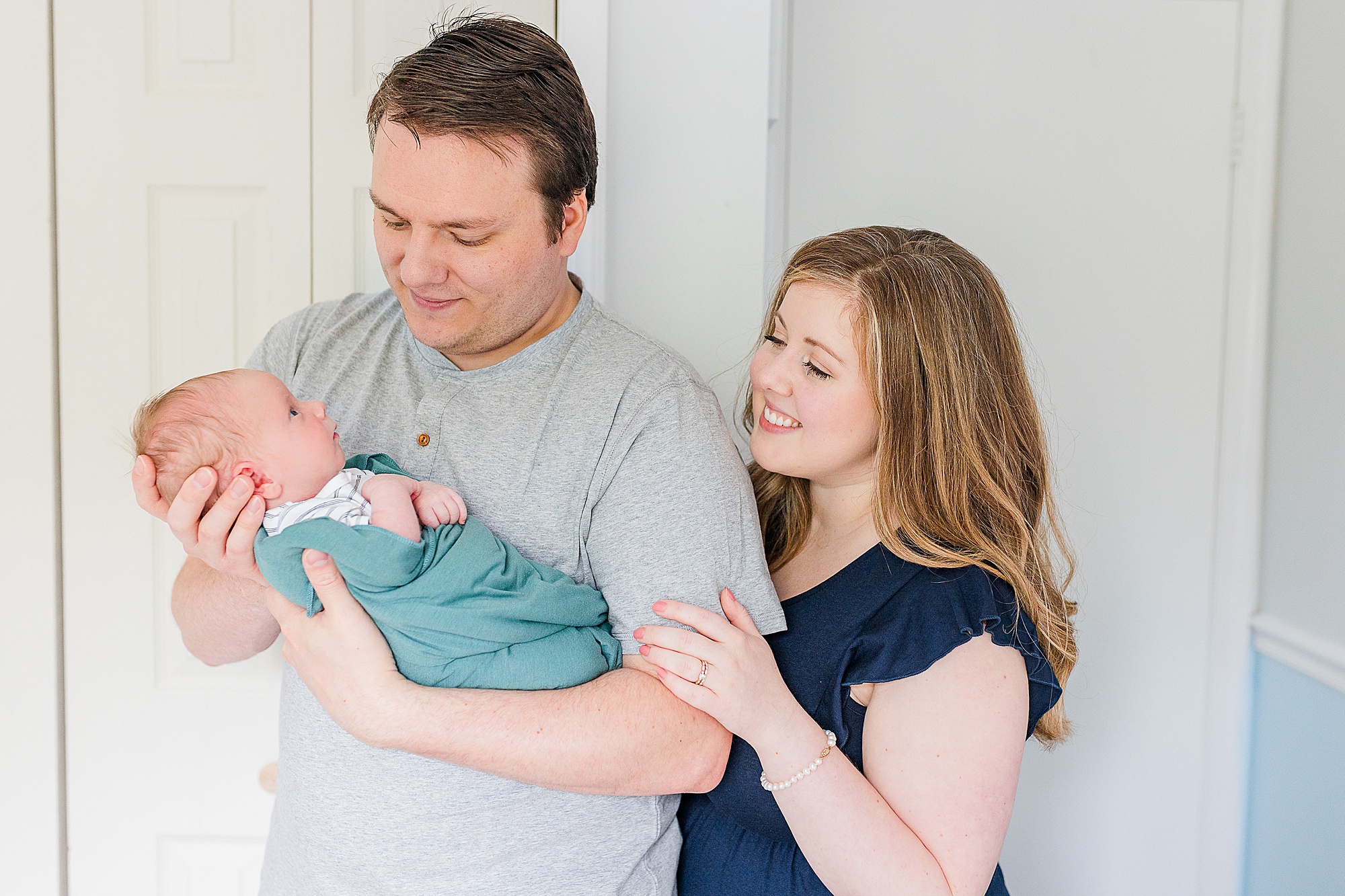 parents look at baby boy during newborn lifestyle photos