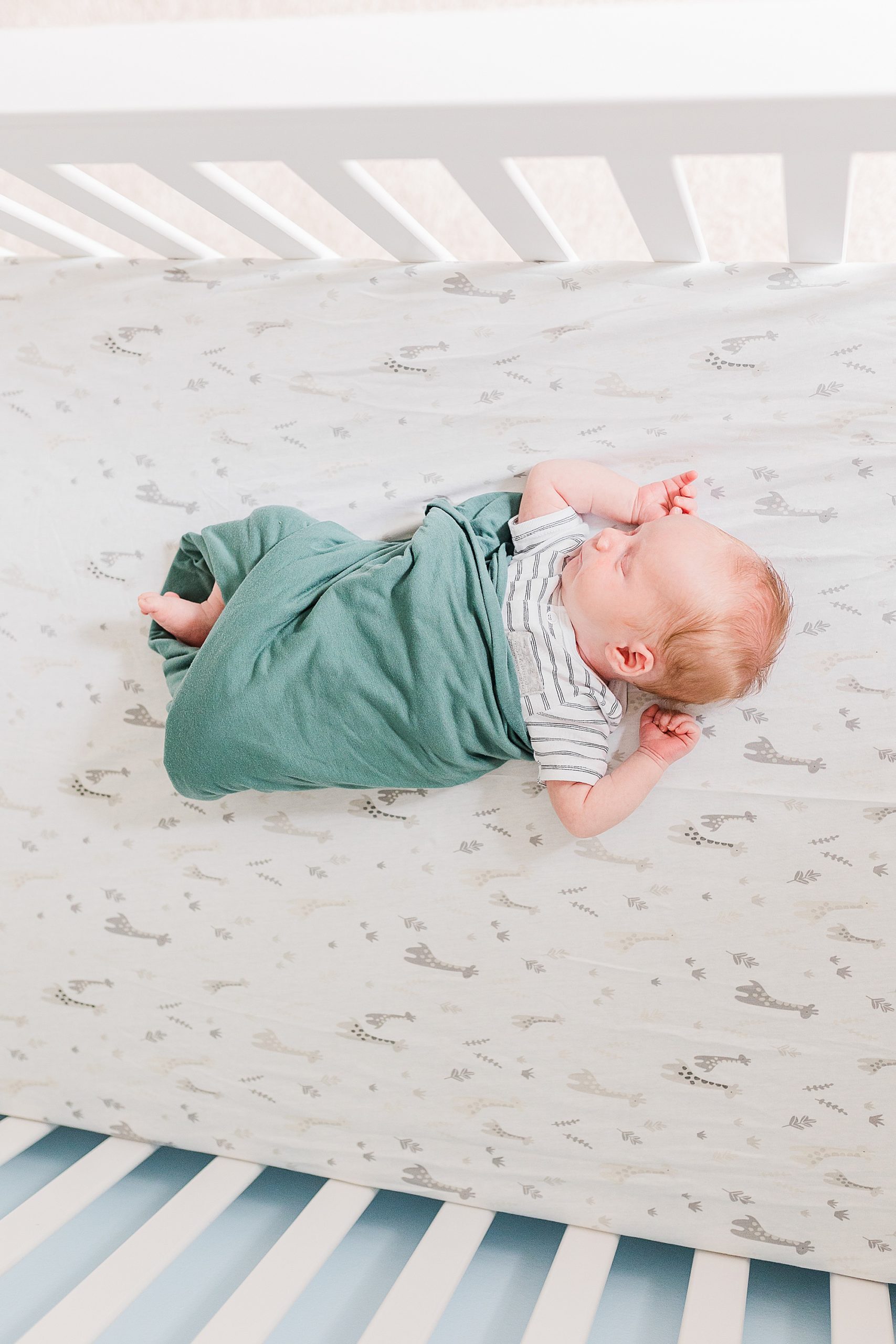 baby sleeps in crib during lifestyle newborn session