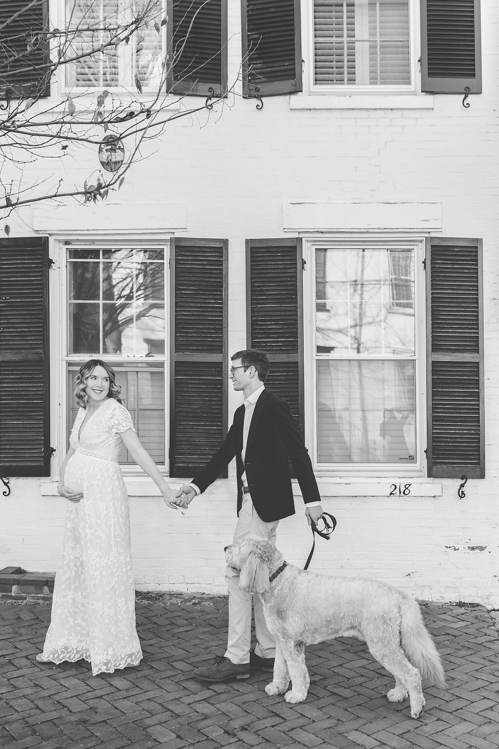 couple walks with dog in Historic Alexandria VA