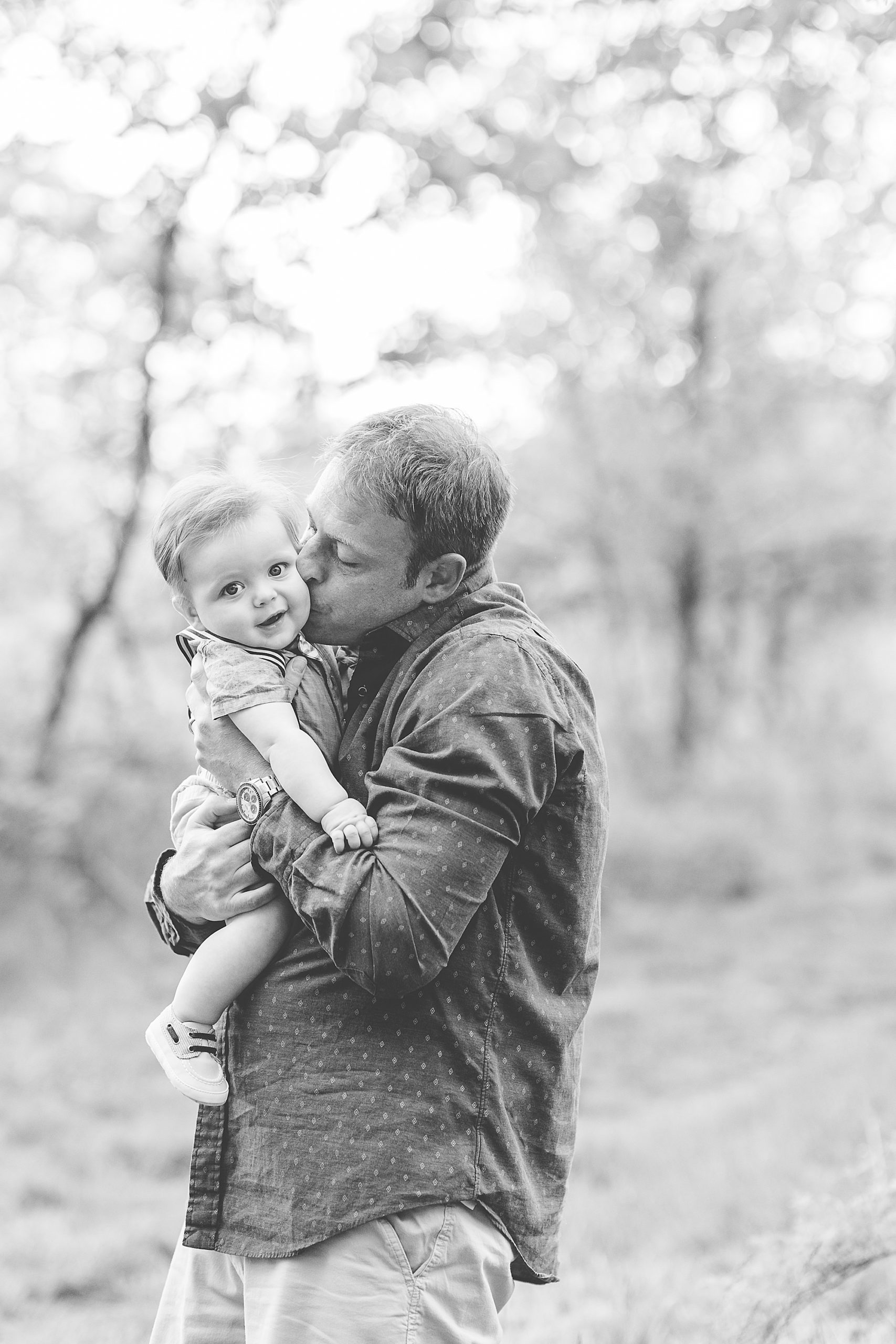 dad kisses son's cheek during family photos in Howard Country MD