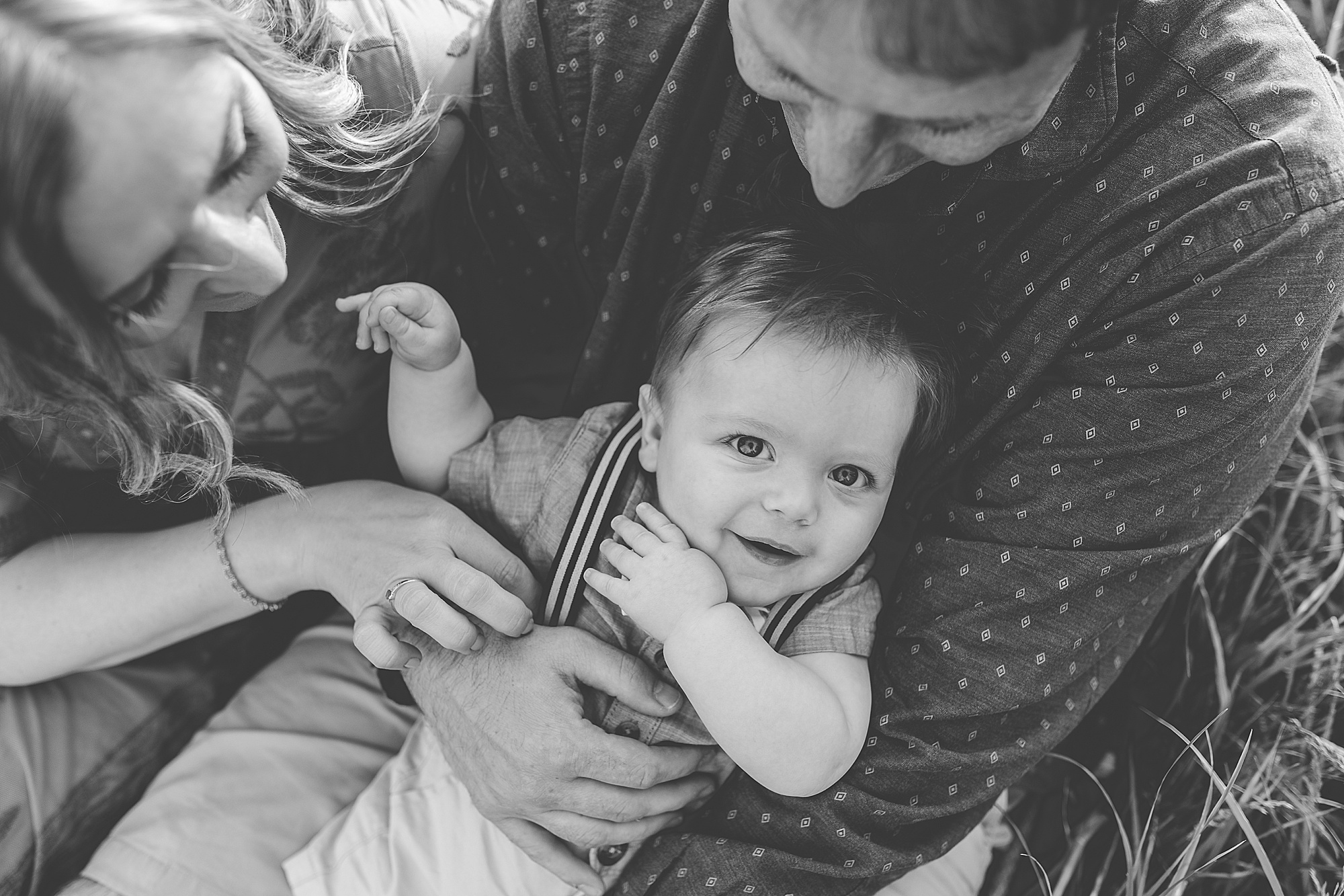 parents snuggle with son during family photos in Maryland 