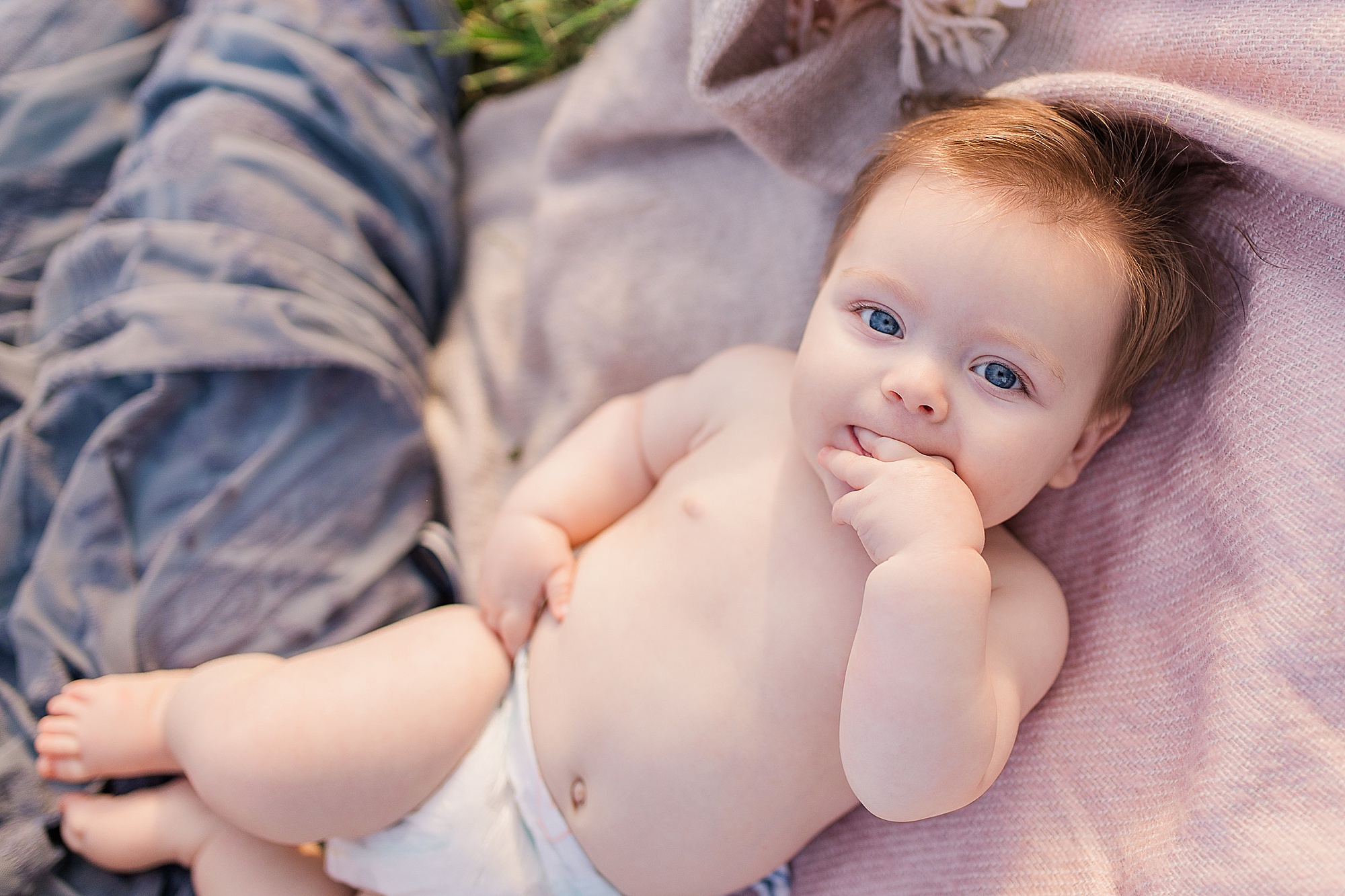 baby lays on blanket during 6 Month Milestone Portraits in Howard County