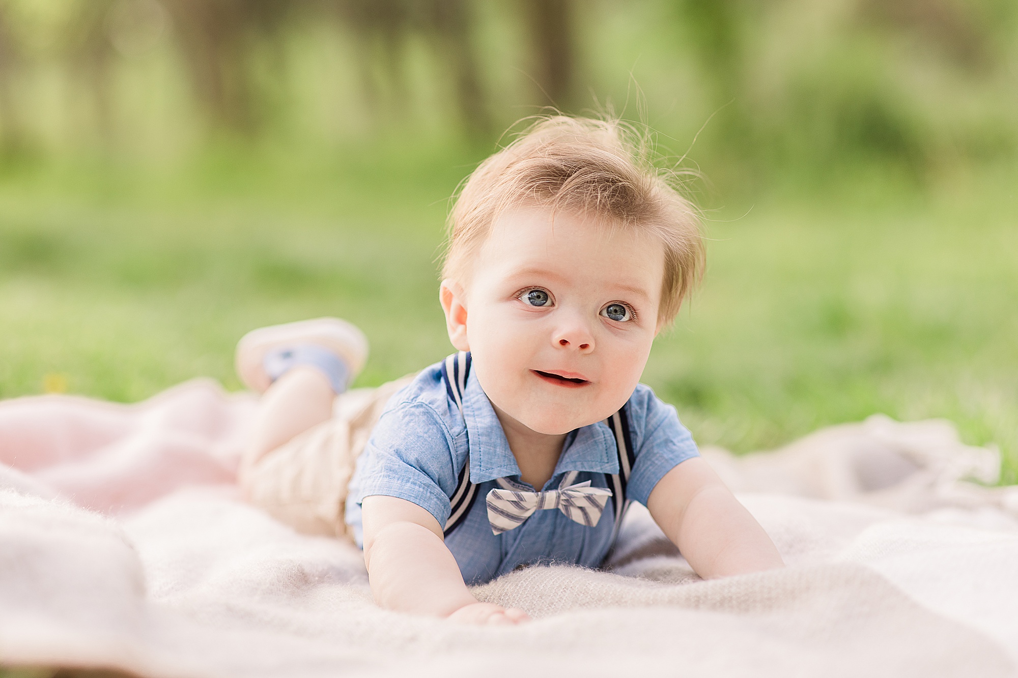 baby rolls on blanket during 6 Month Milestone Portraits
