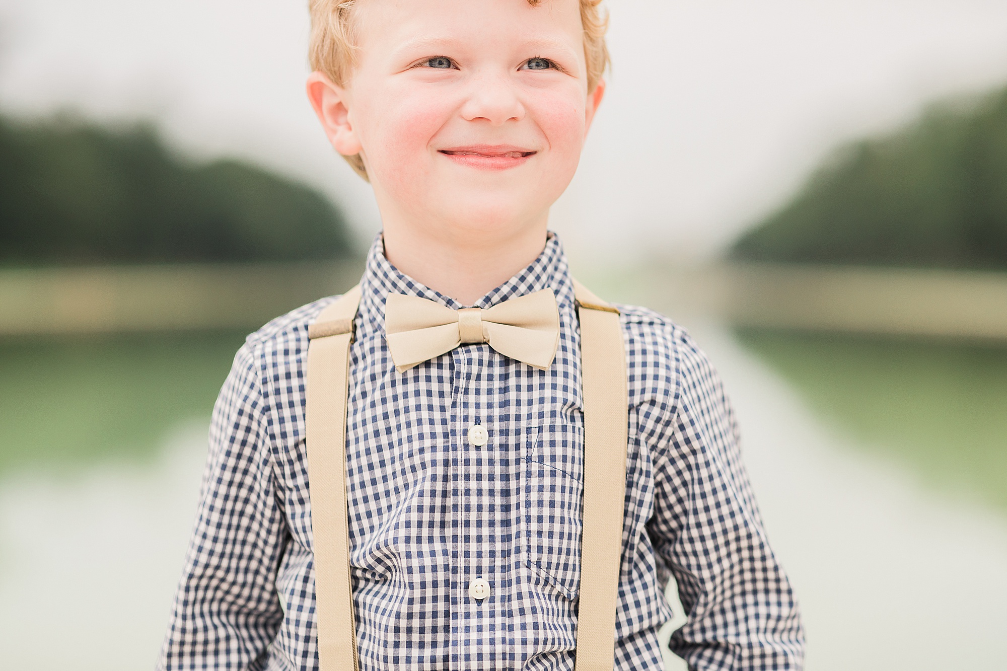 toddler in suspenders and bow tie smiles in DC