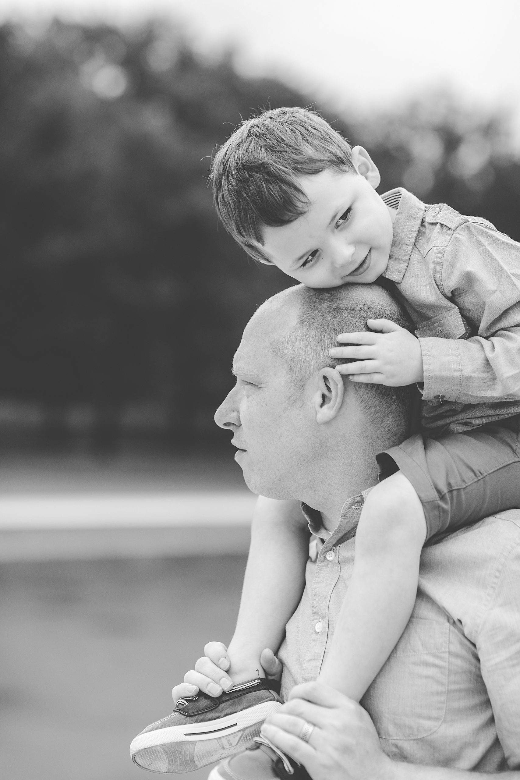 son sits on dad's shoulder during Washington DC Family Portraits