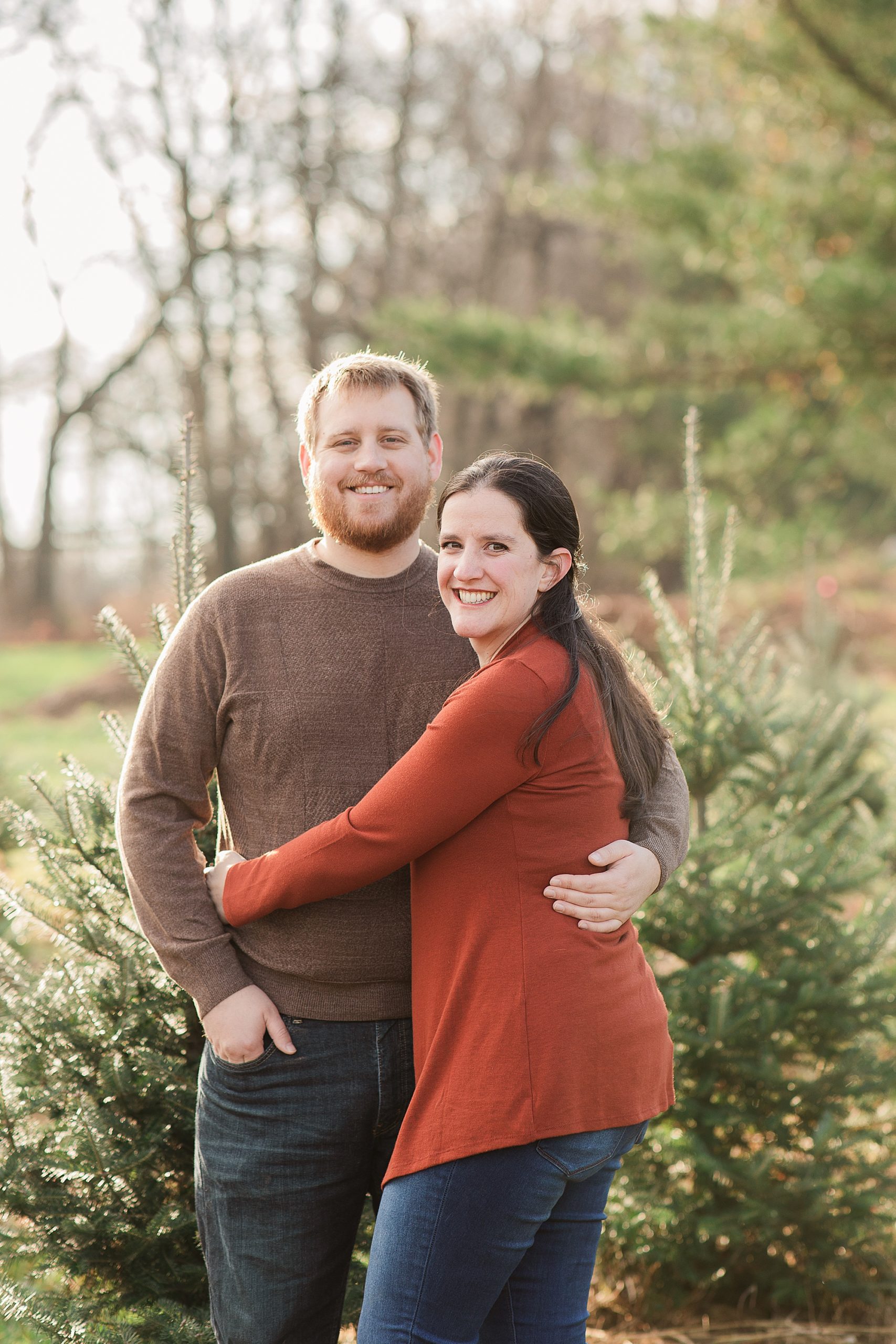 couple hugs during Greenway Tree Farm family photos