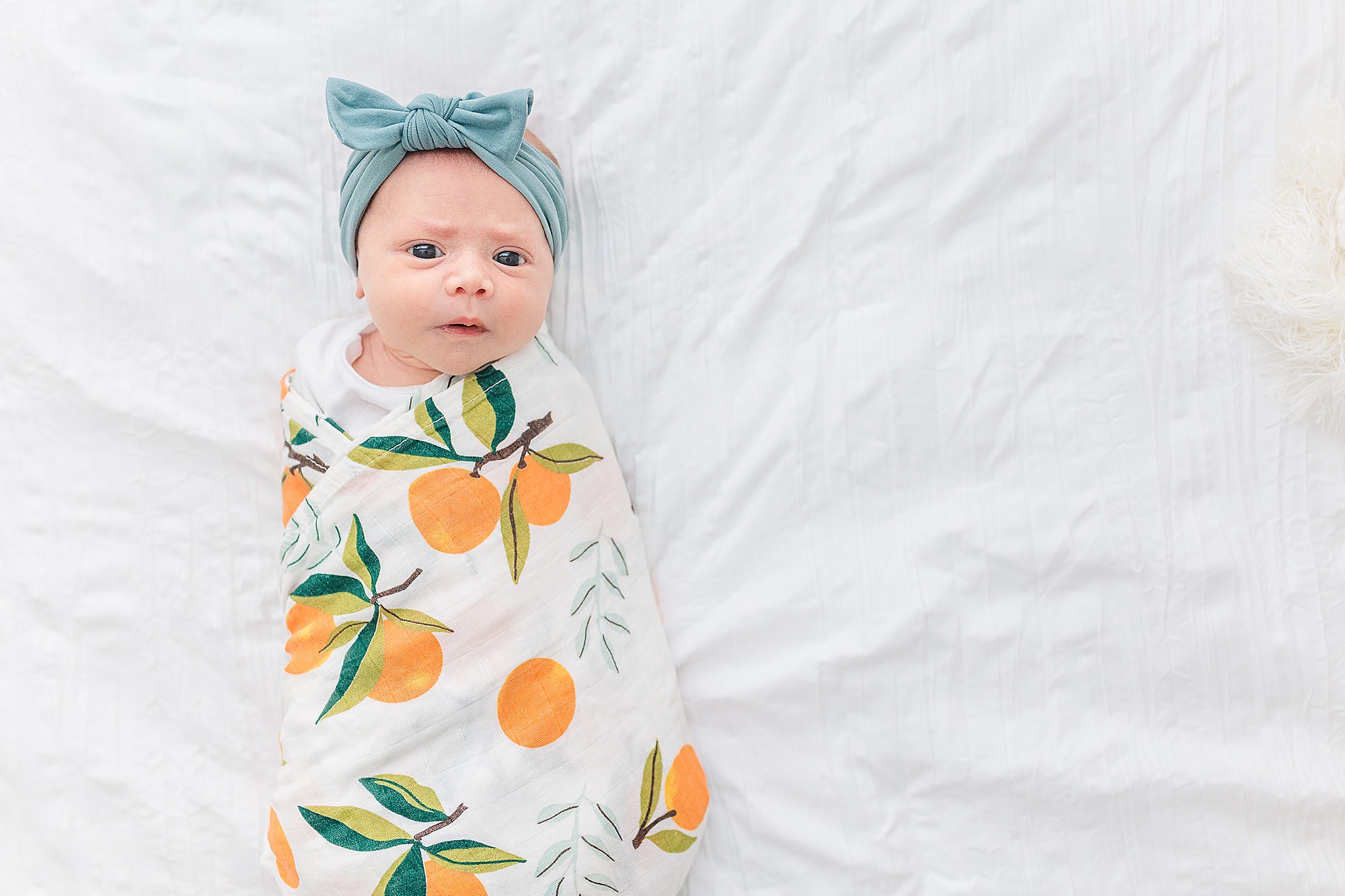 baby girl lays in citrus wrap during Lifestyle Newborn Session in Annapolis