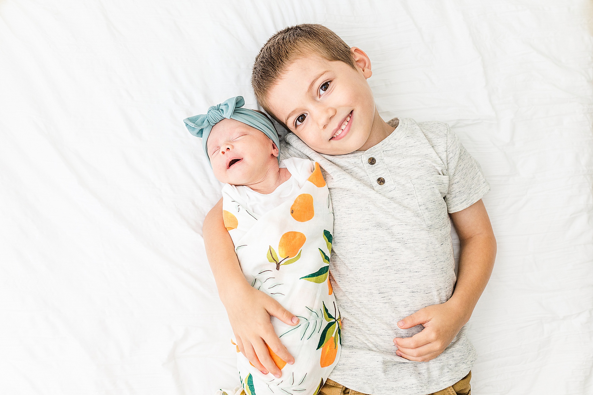 brother holds sister during Lifestyle Newborn Session in Annapolis
