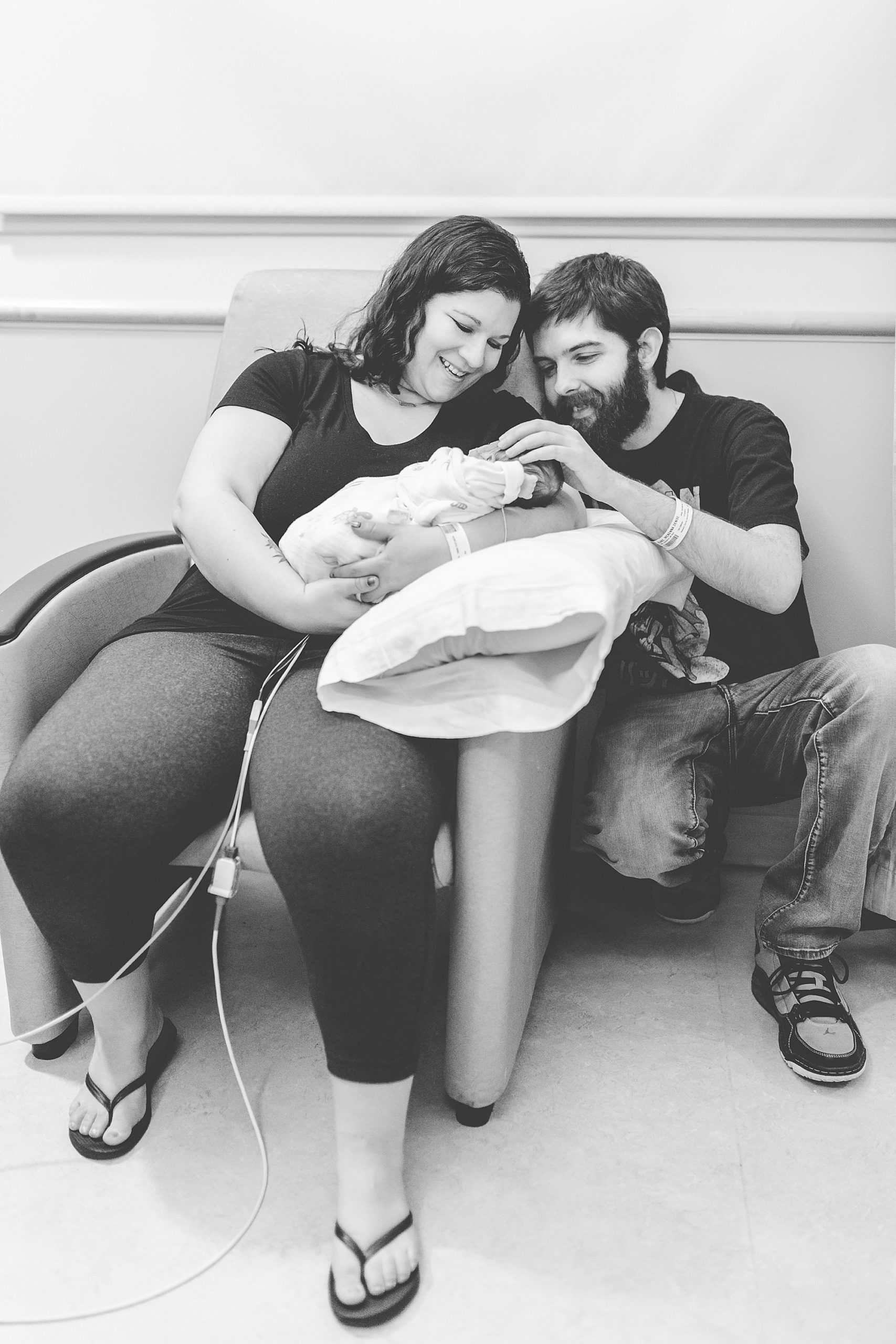 new parents look at baby girl during NICU newborn portraits
