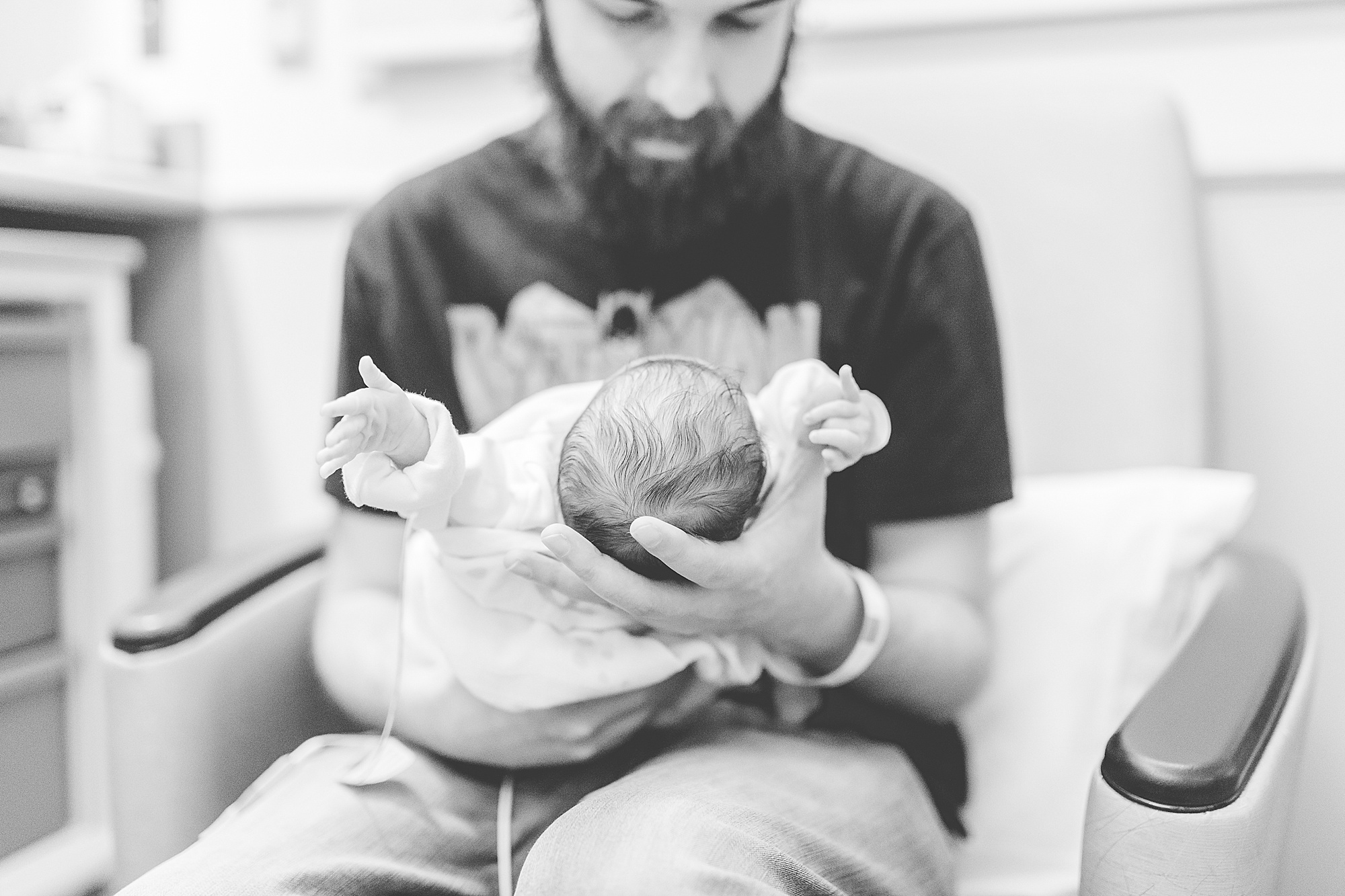 dad looks at daughter during NICU newborn portraits