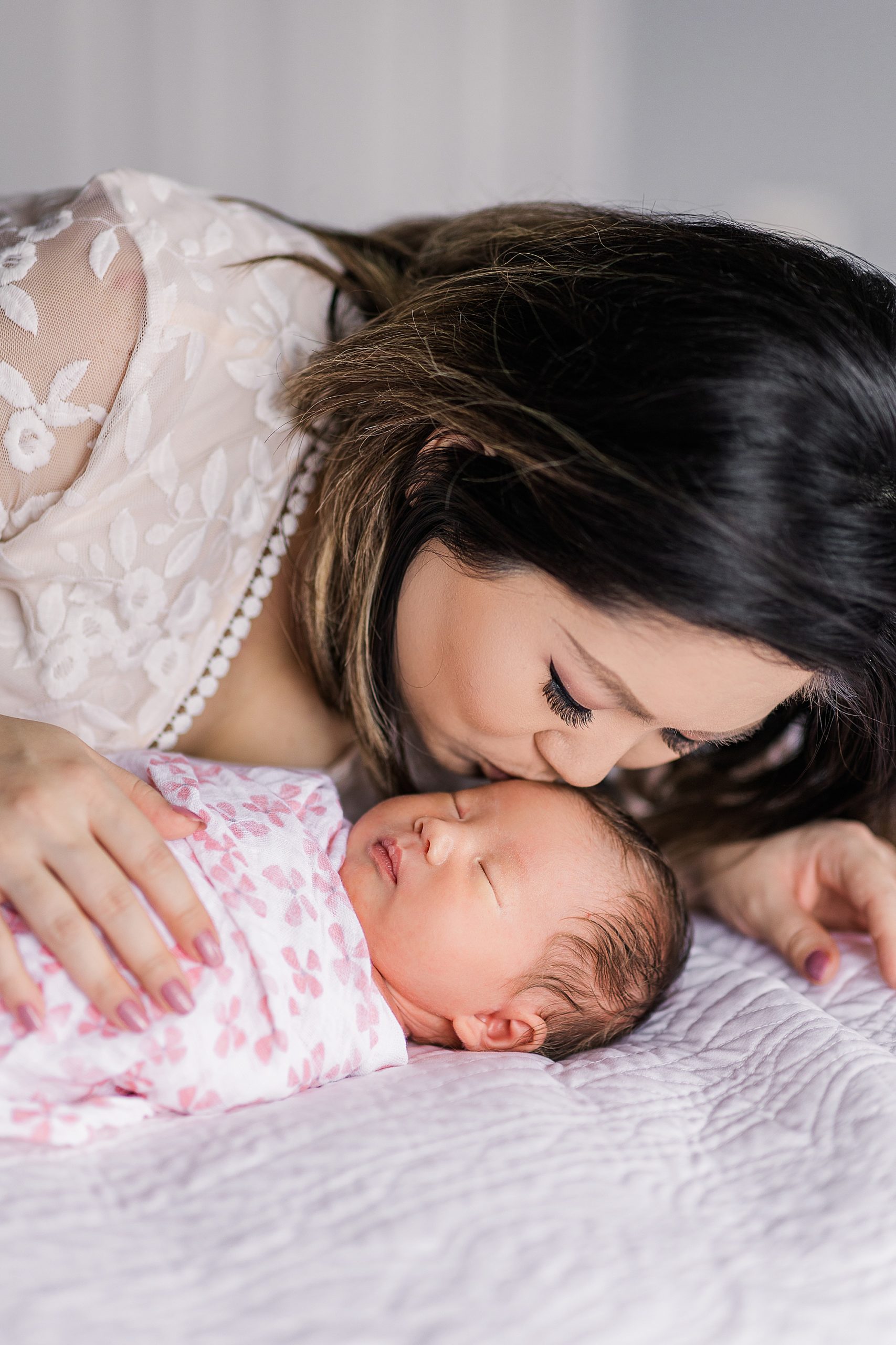 mom kisses daughter during VA lifestyle newborn portraits
