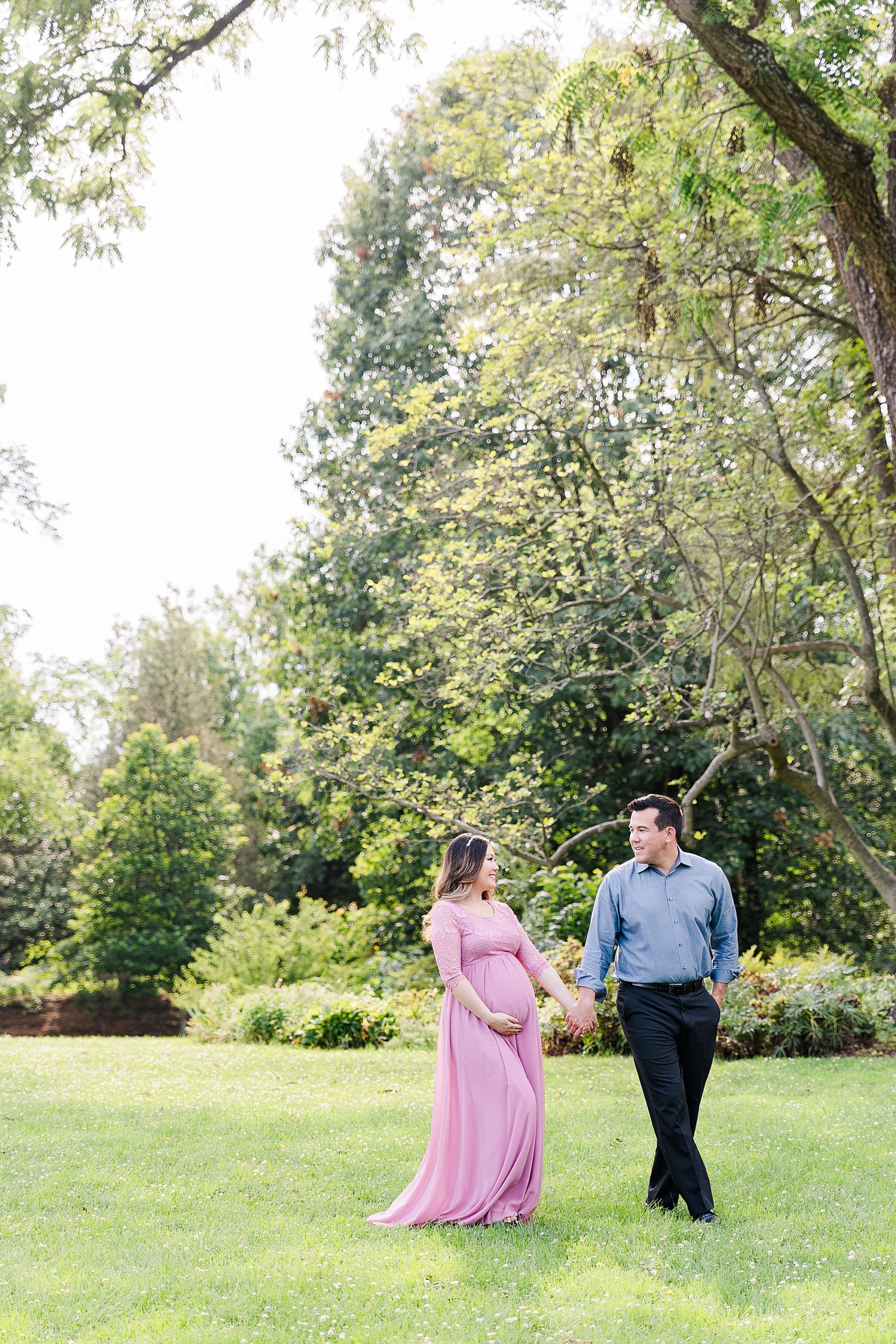 couple walks through Green Spring Gardens during maternity session