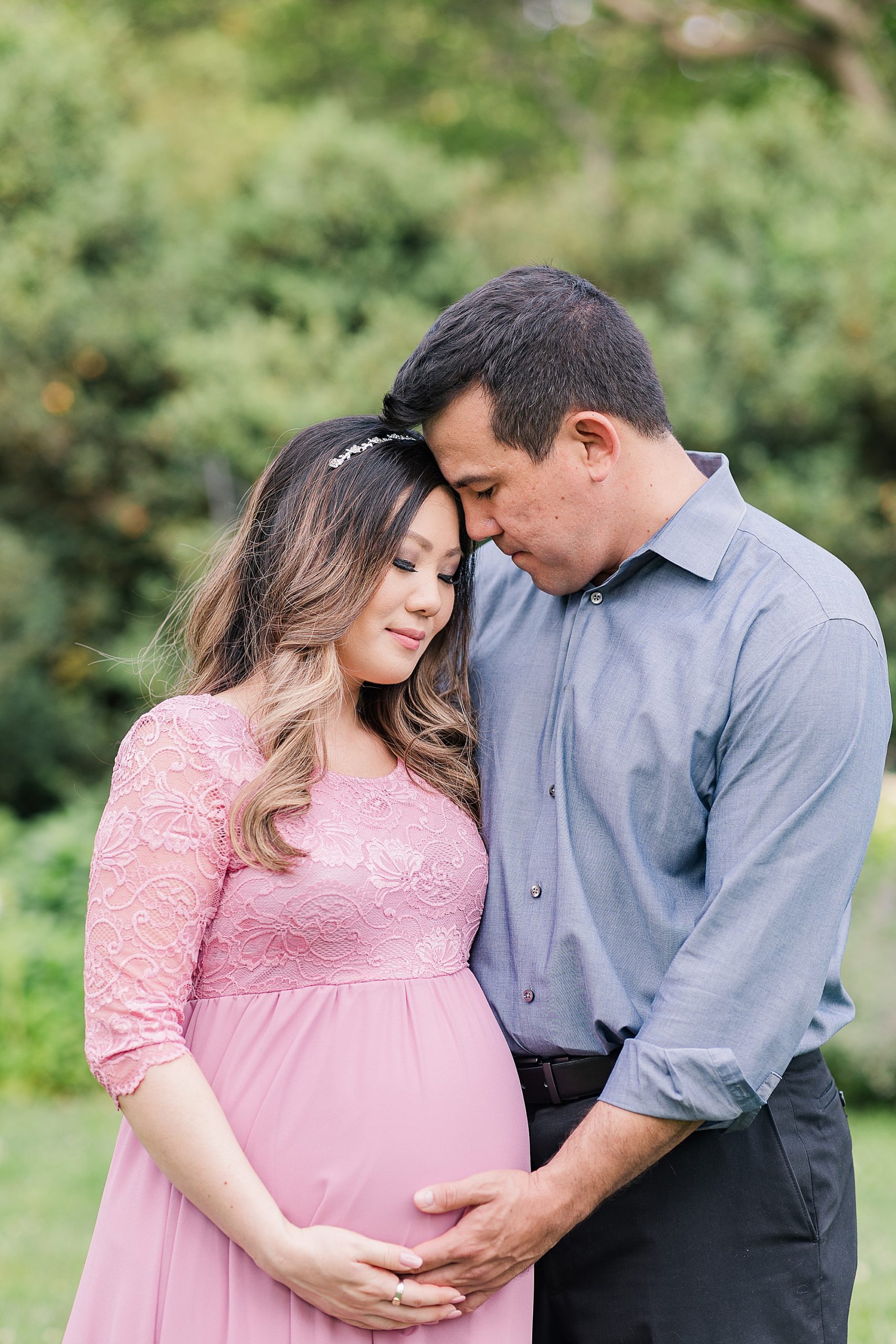 couple stands with heads together during VA maternity photos