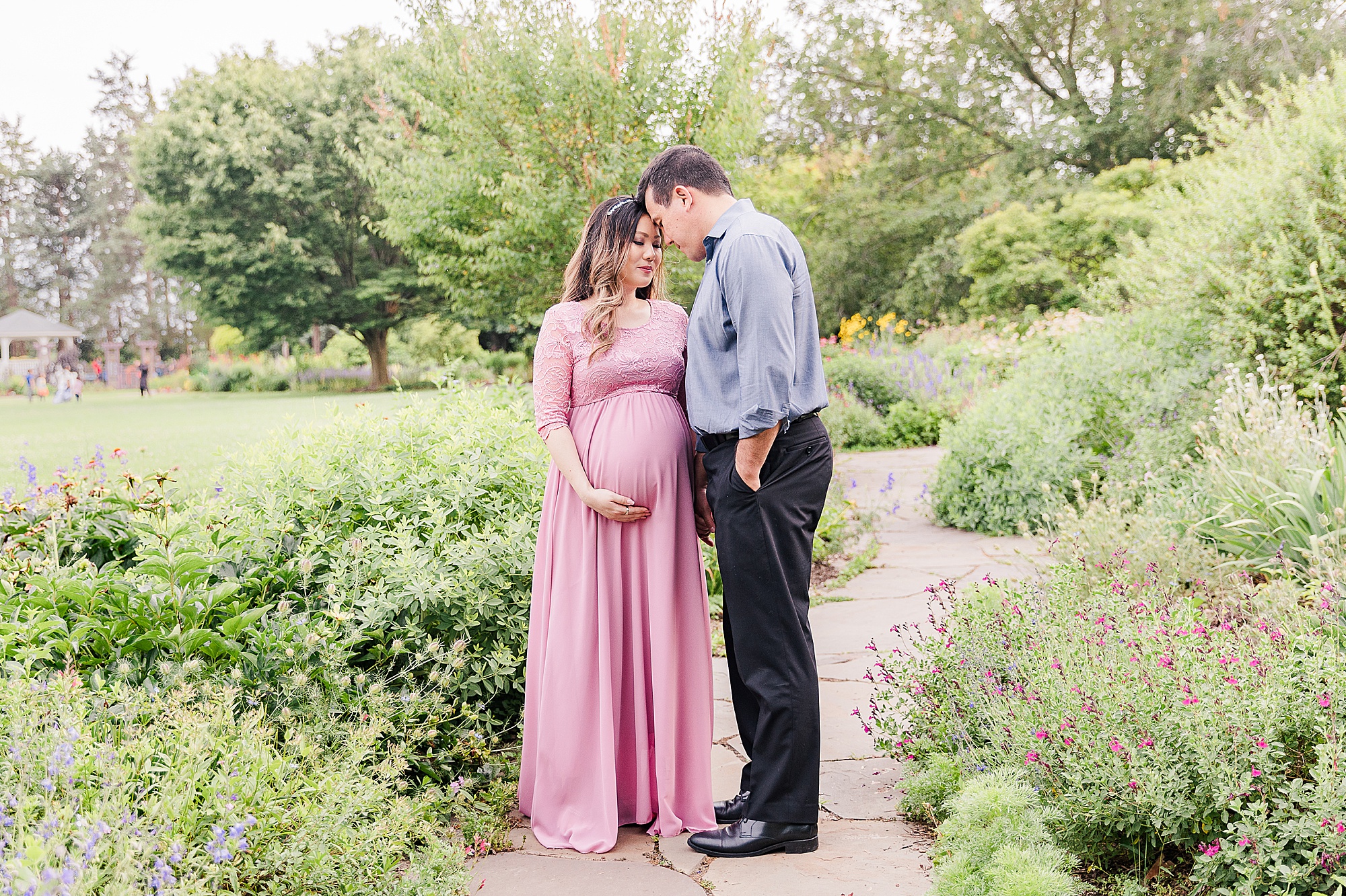 couple stands in Green Spring Gardens during maternity session