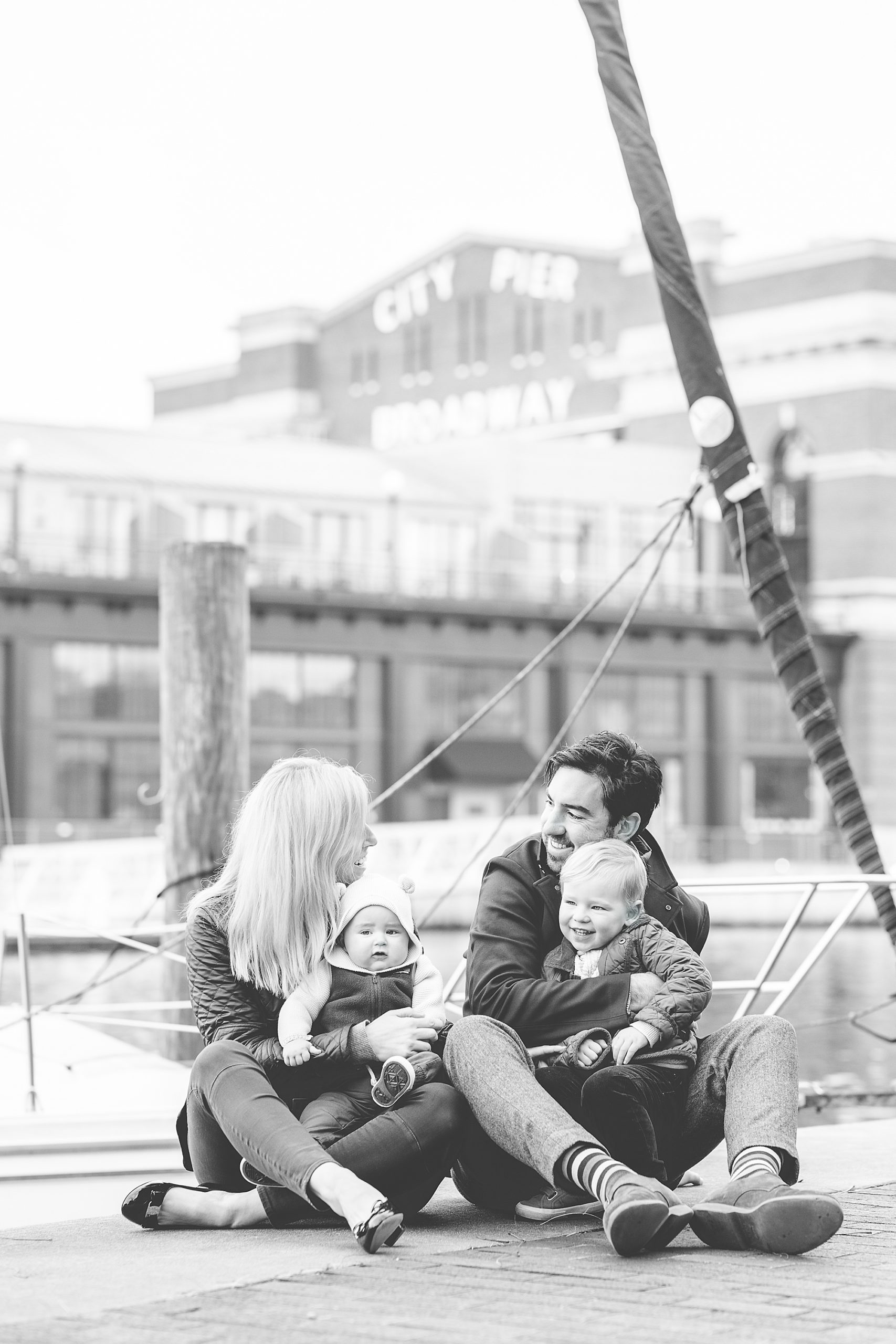 family sits on Maryland dock during winter portraits 