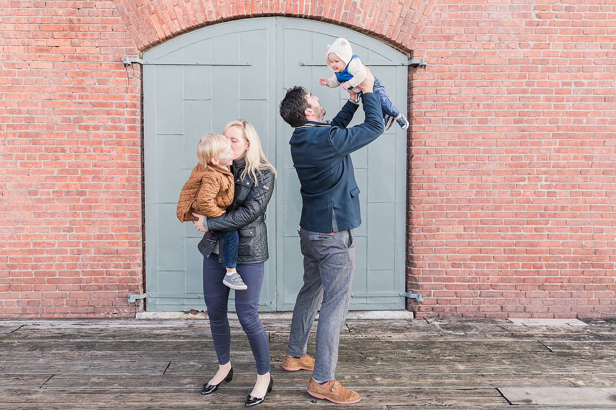 parents play with toddlers during Fells Point family portraits 
