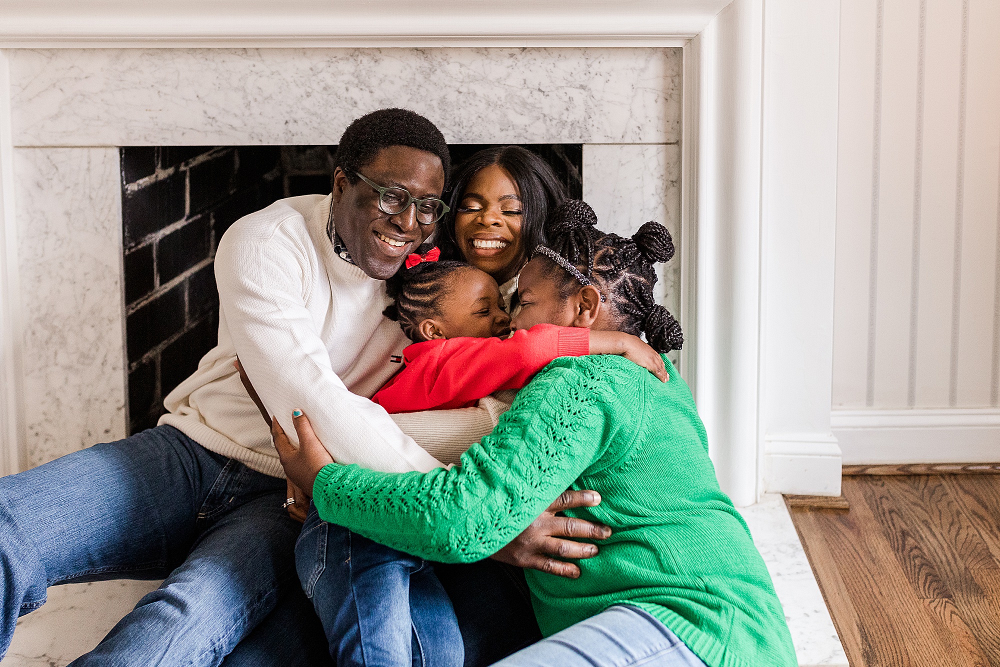 family hugs by fireplace during Howard County In-Home Holiday Family Session
