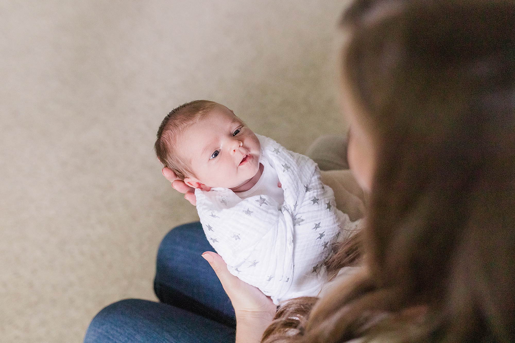 baby looks at mother during Annapolis lifestyle newborn session