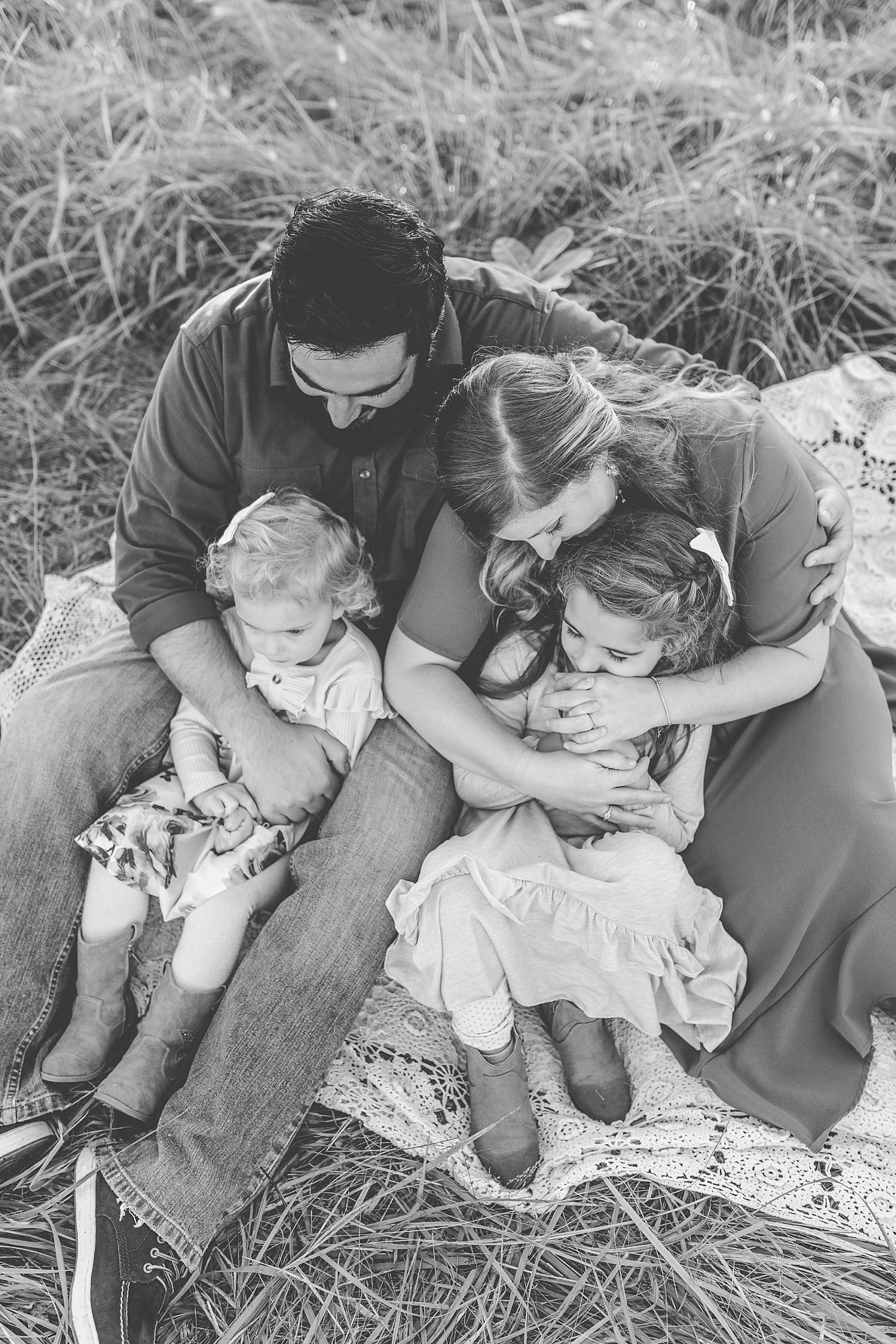 family of four hugs during Howard County Conservancy family session