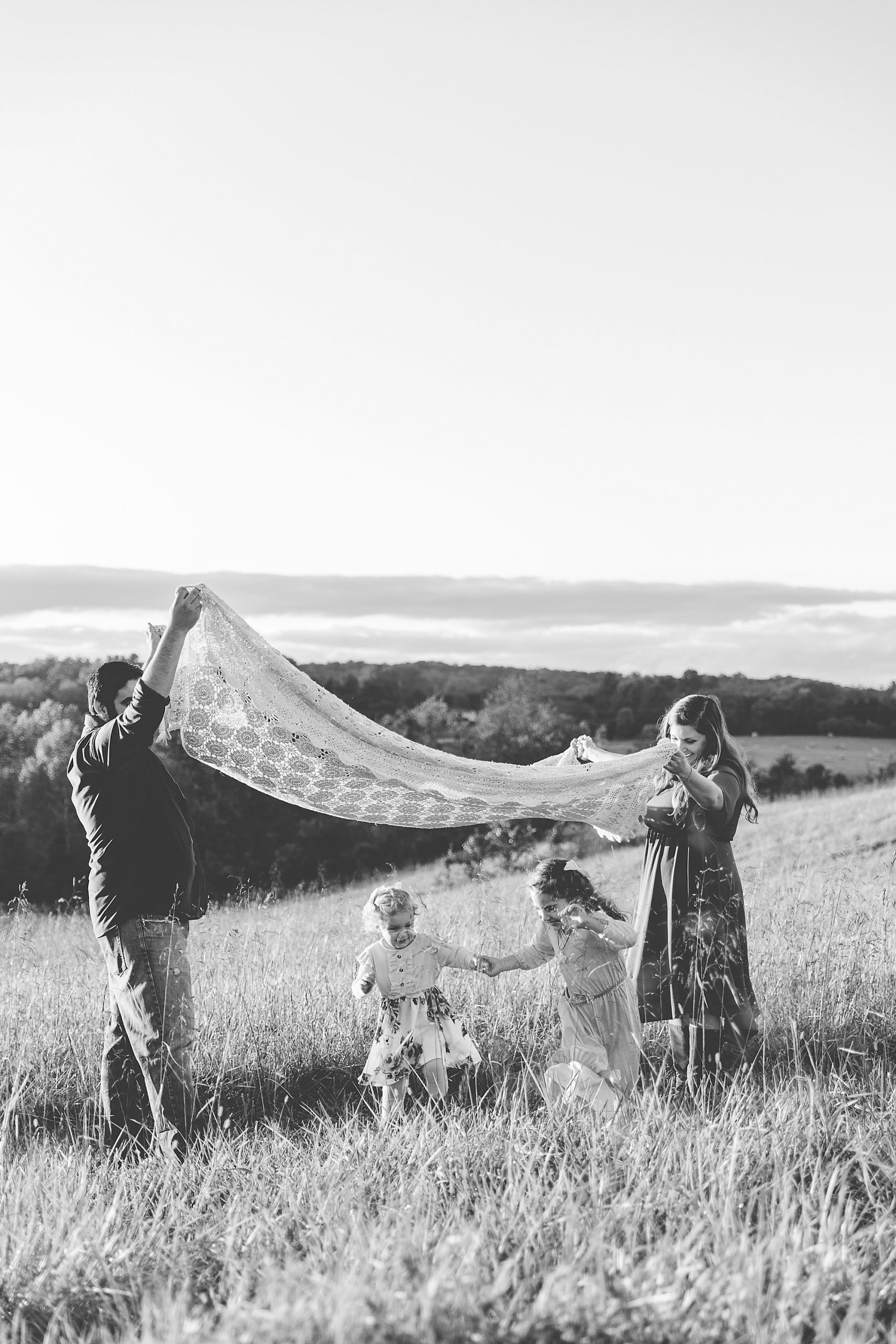 family plays blanket game during Howard County Conservancy fall family session
