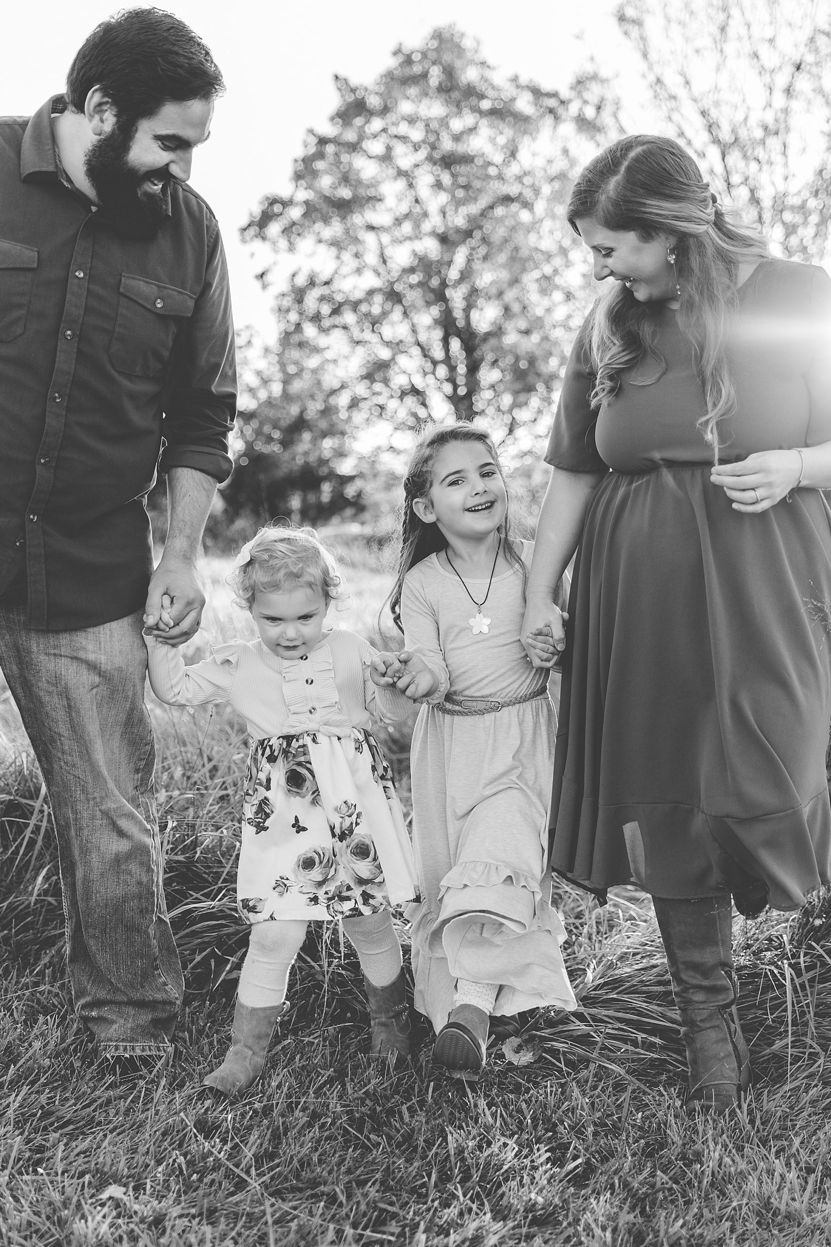 parents walk with daughters during Howard County Conservancy family portraits 