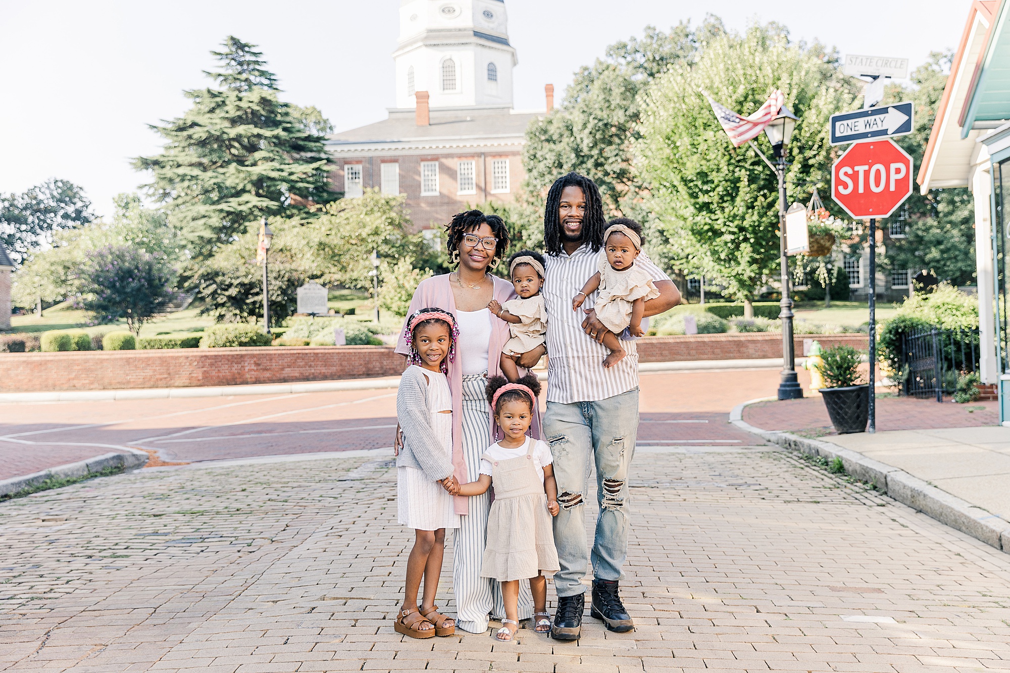 family poses in front of Annapolis State House