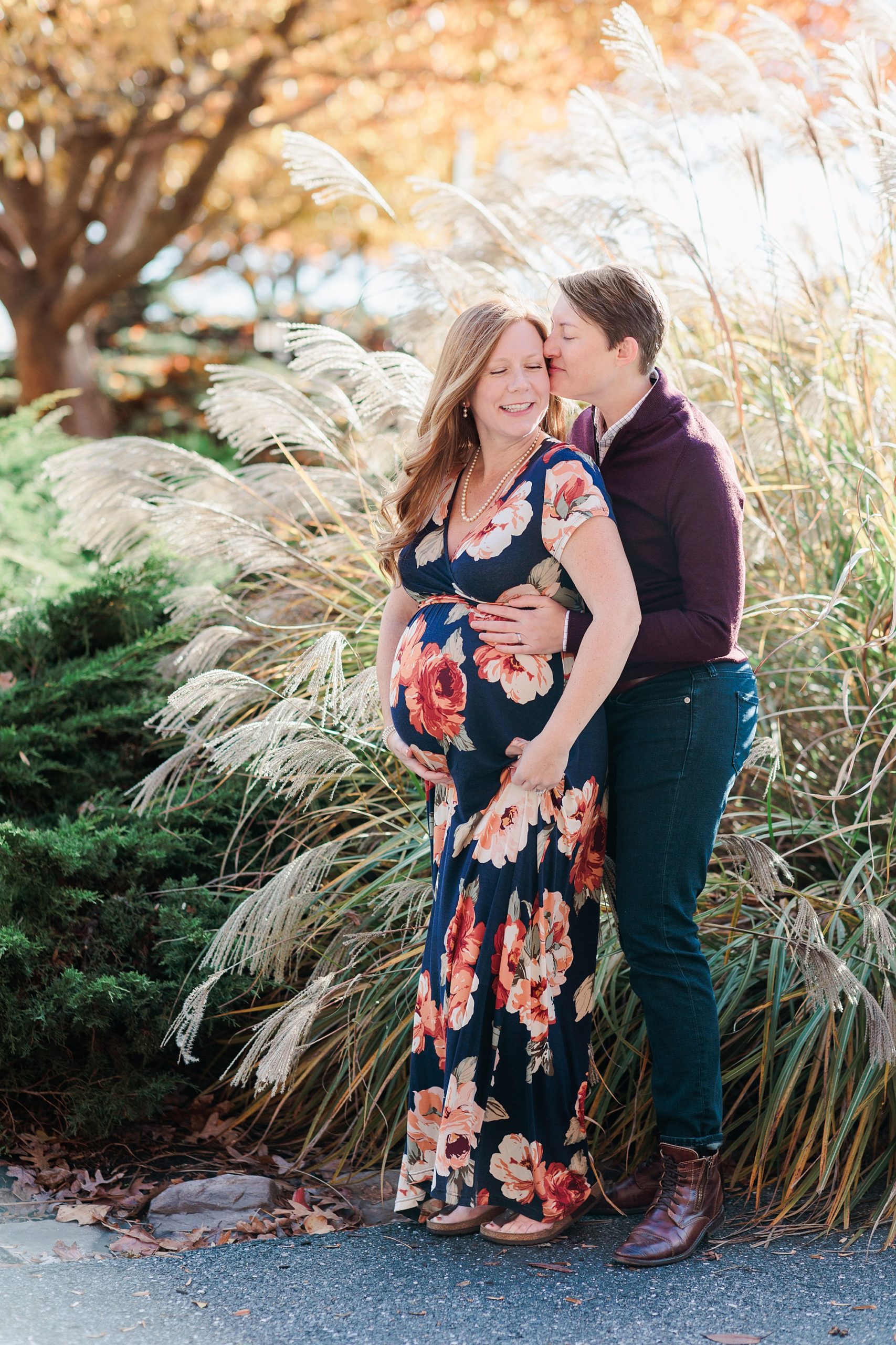 fall maternity portraits in Ellicott City for same-sex couple at sunset in tall grass