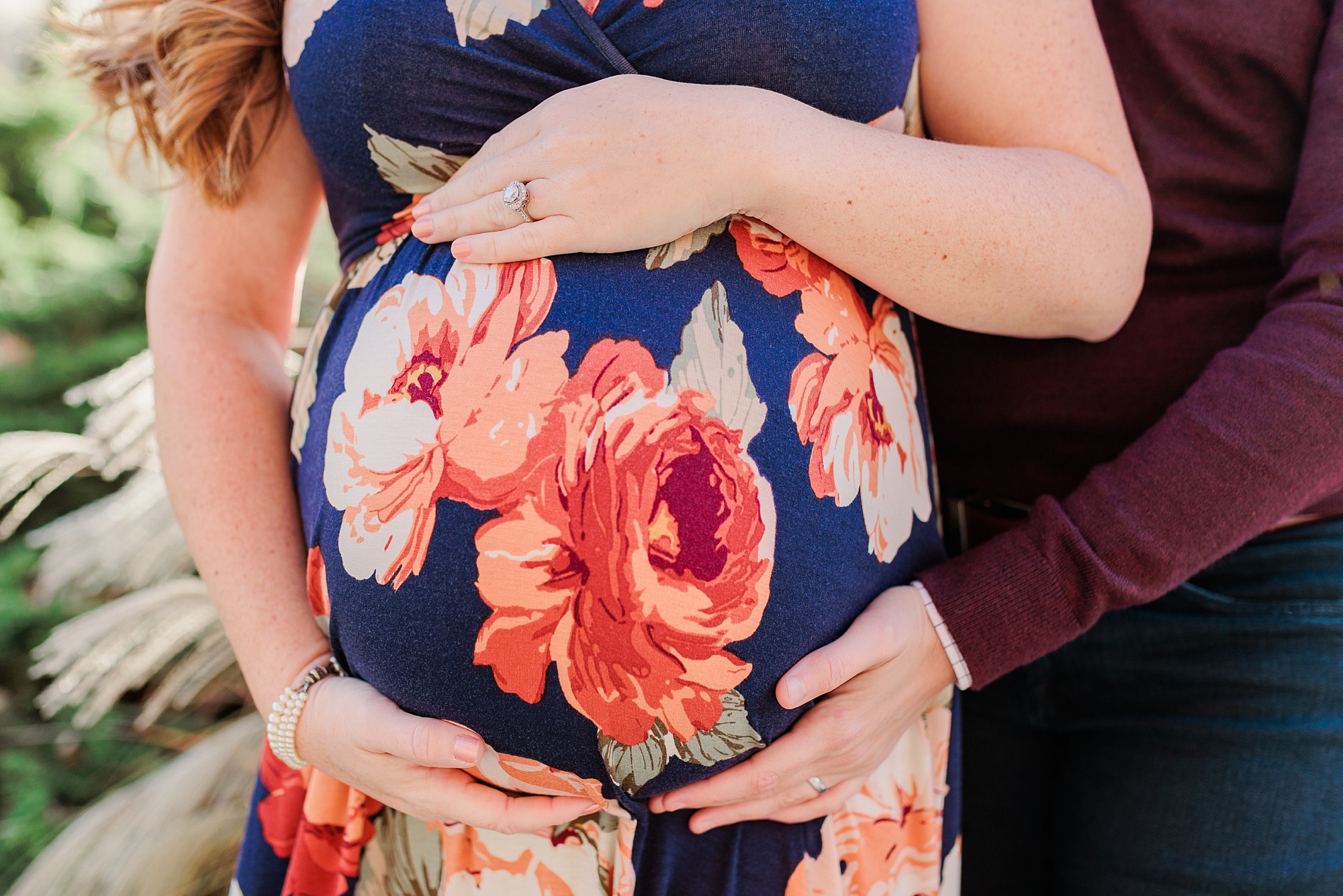 women hold mom's belly during maternity session