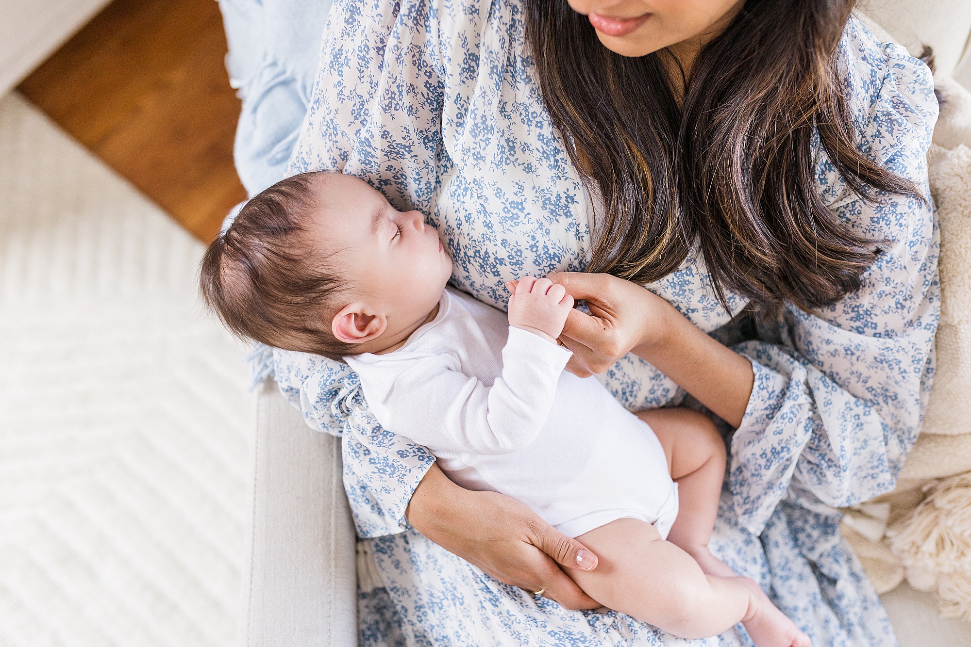 baby sleeps in mom's arms during lifestyle newborn session