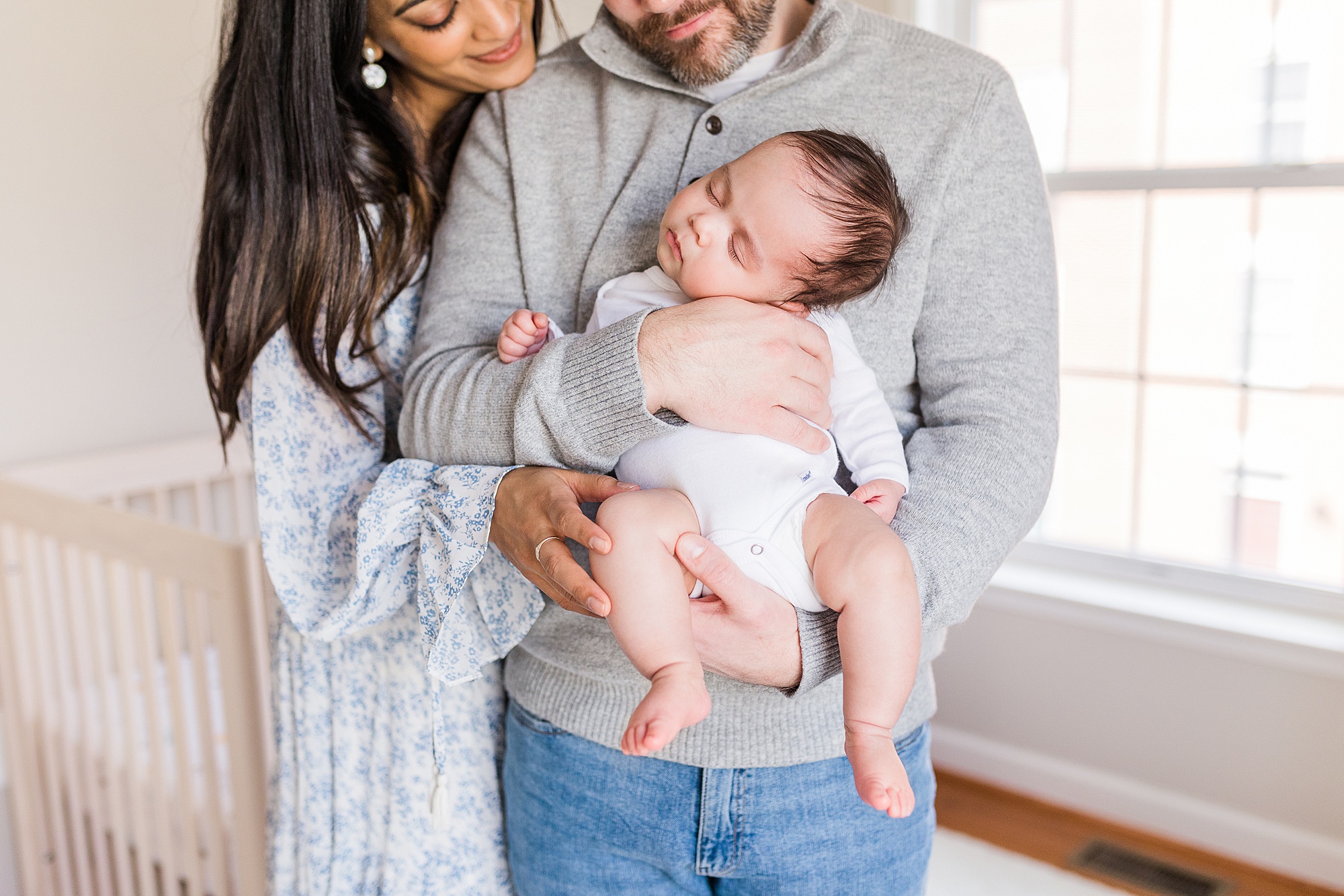 parents hold baby boy during lifestyle newborn session