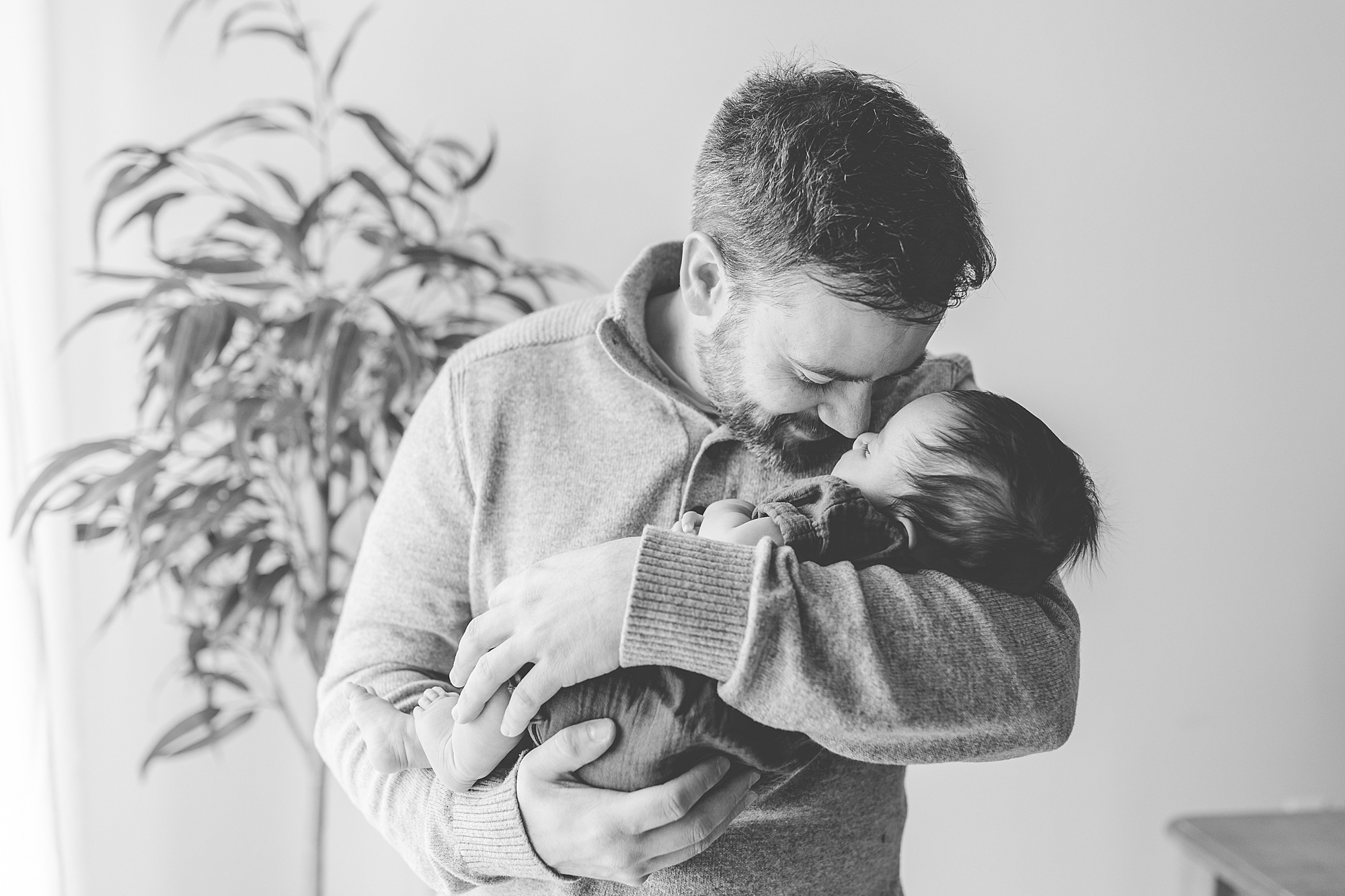 dad nuzzles baby's nose during lifestyle newborn session