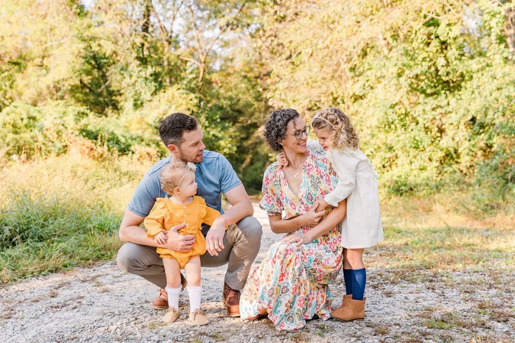 family of four poses together in Maryland during fall family photos