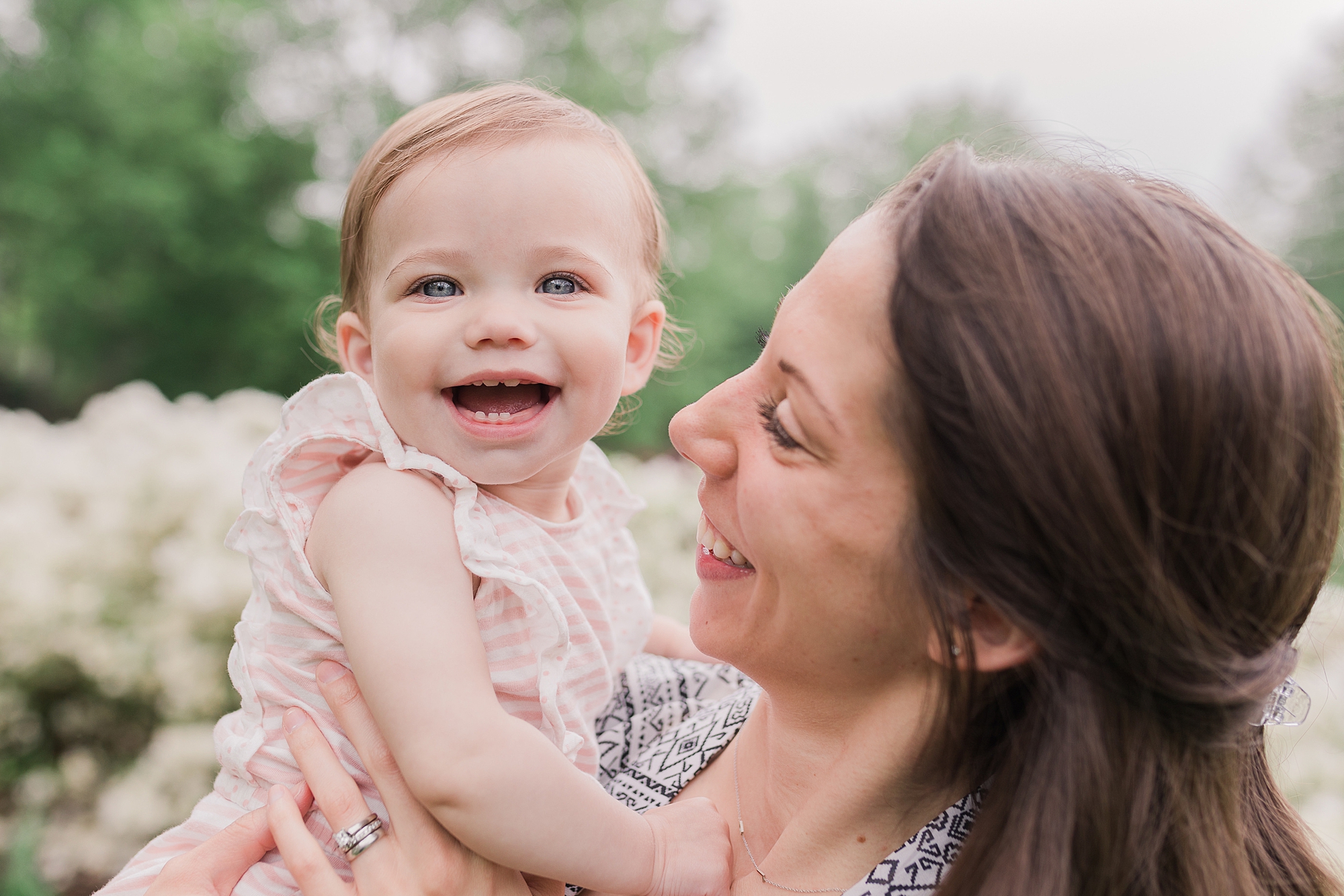 mom laughs with little girl during Sherwood Gardens milestone portraits