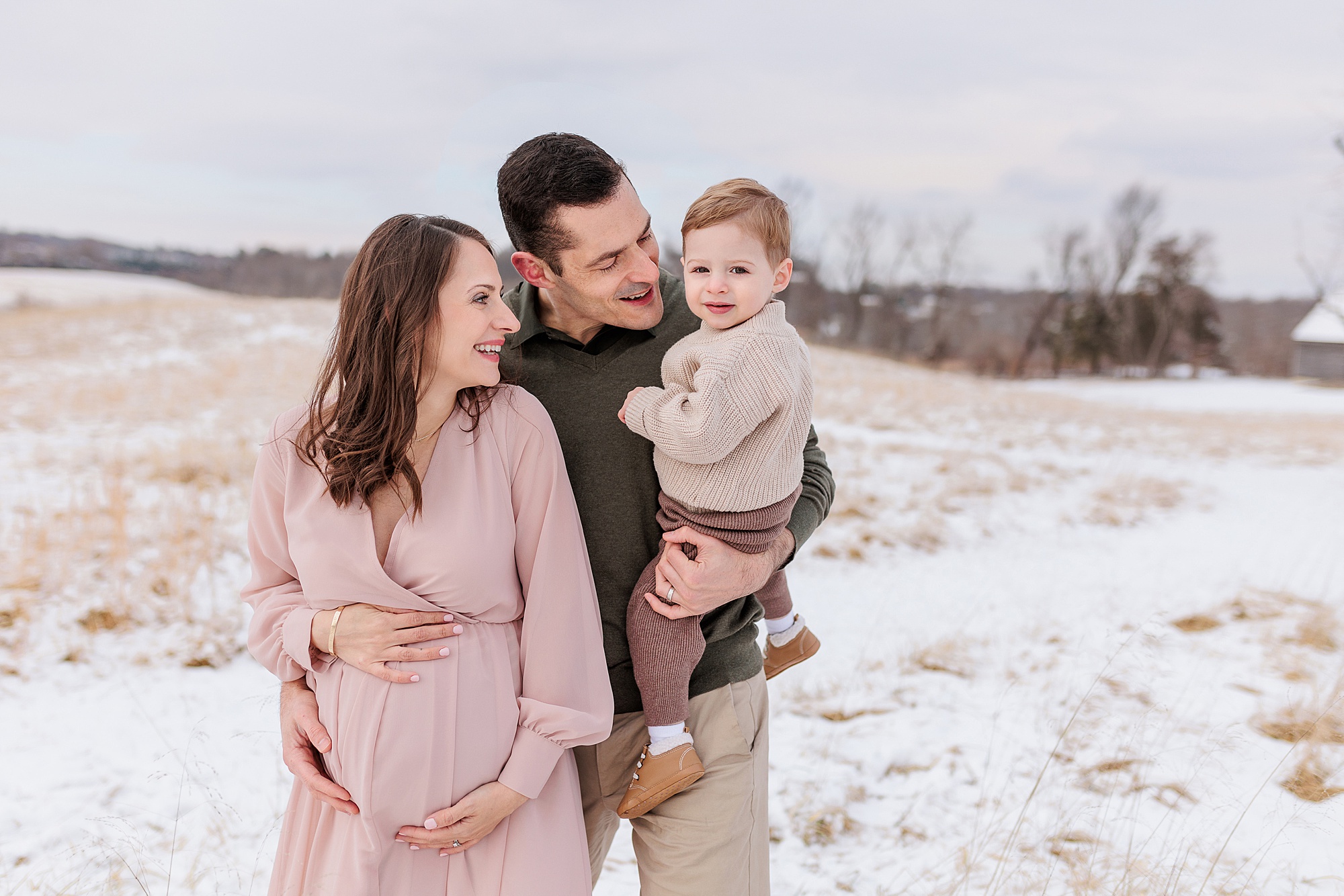 snowy maternity session for expecting mother and family
