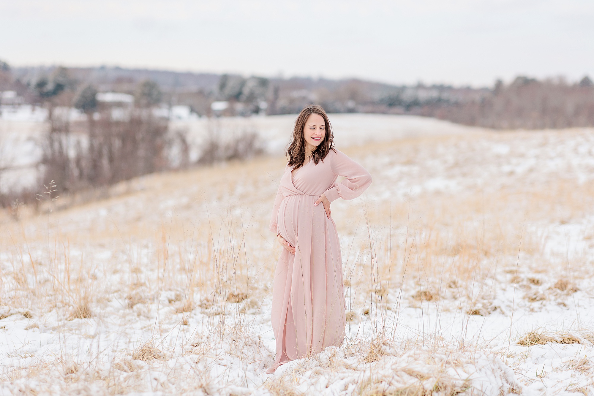 mom in pink maternity gown poses in Howard County field