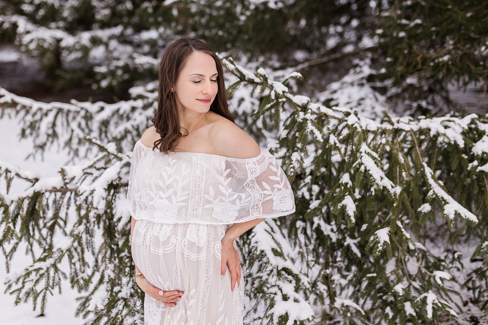 snowy maternity session for Howard County mother in off-the-shoulder lace maternity gown