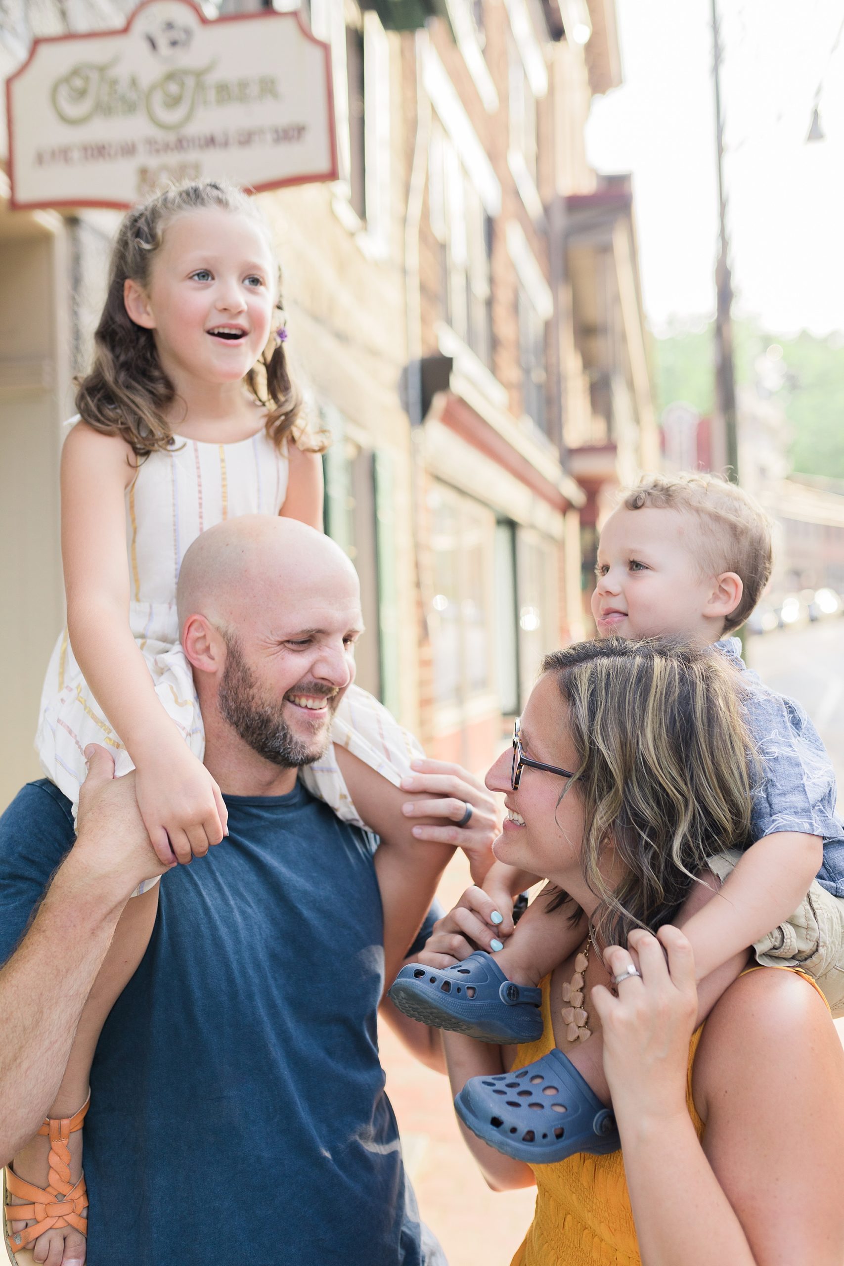parents hold kids on shoulders during Historic Ellicott City family portraits