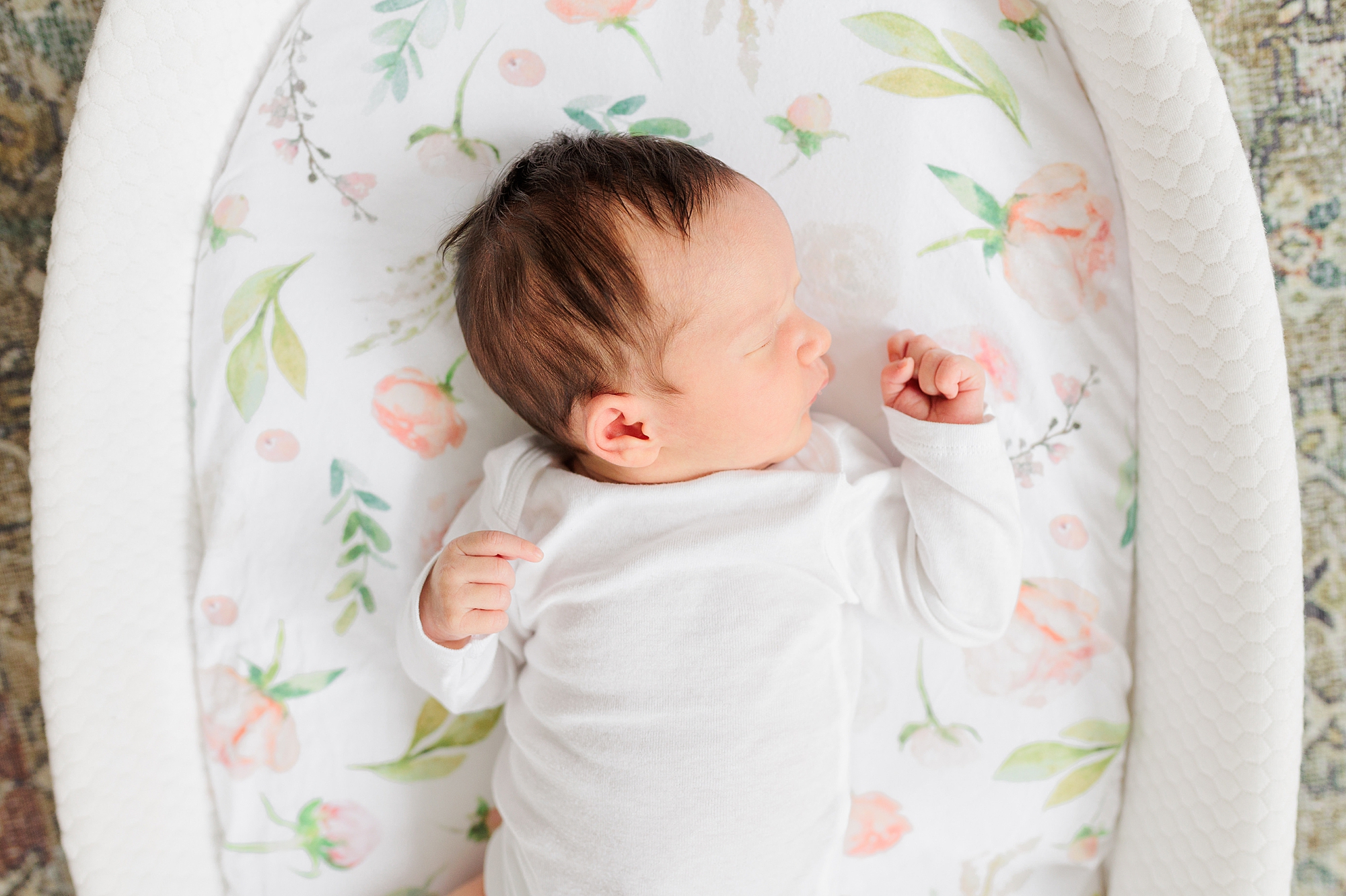 baby girl lays in white basket during Silver Spring MD newborn lifestyle session