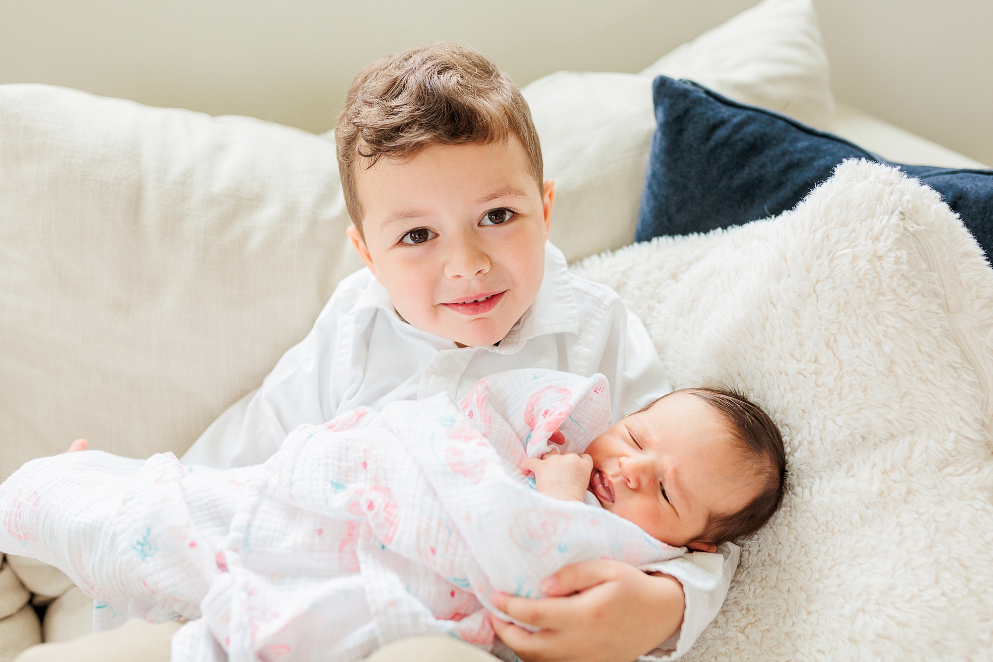 toddler holds new baby sister during lifestyle photos