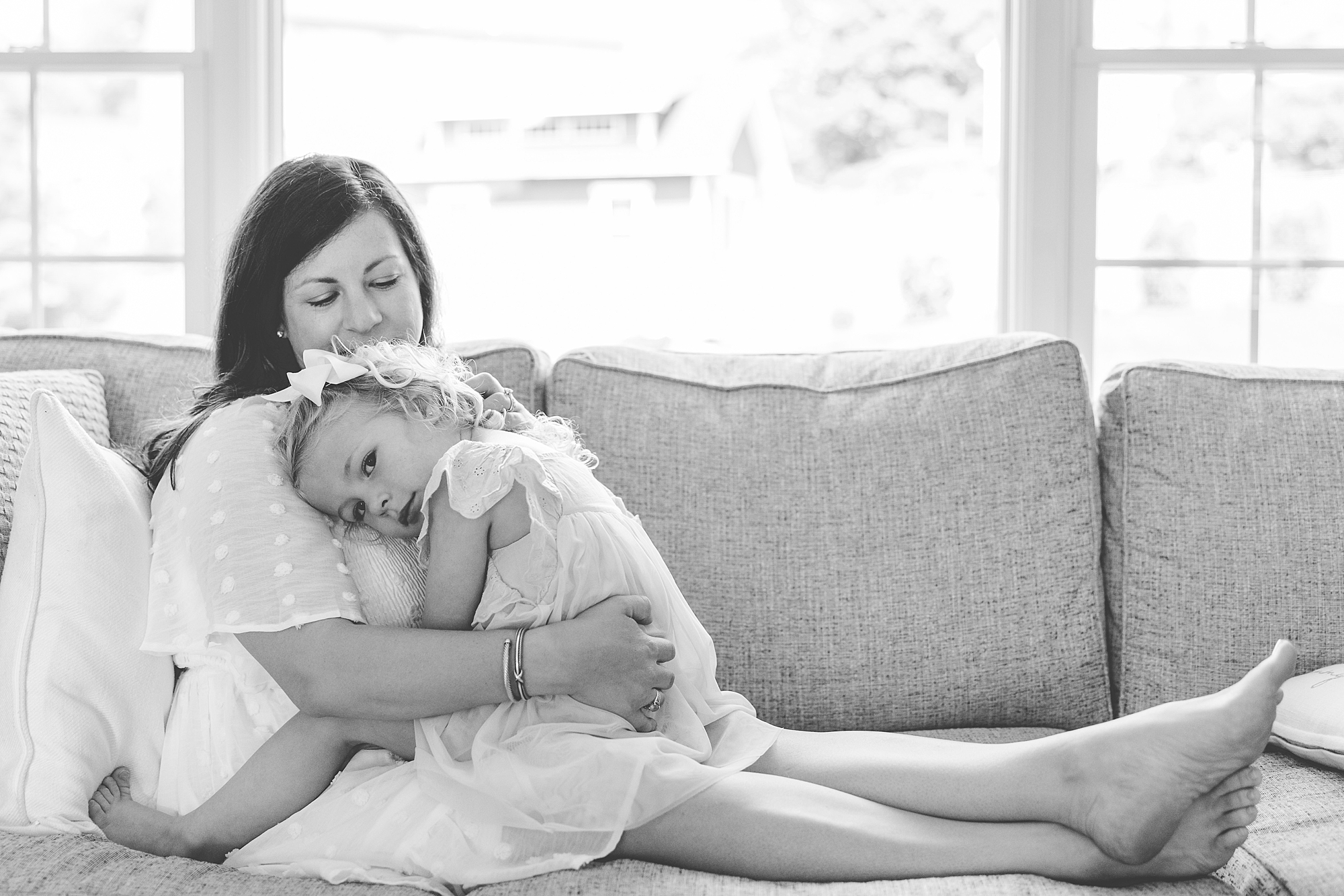 toddler lays on mom's chest during lifestyle photos in Maryland home