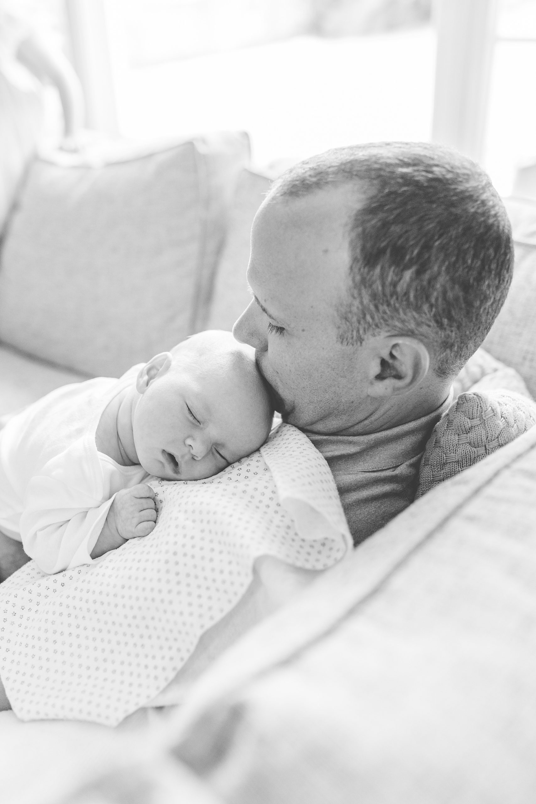 baby lays on dad's chest during lifestyle newborn session