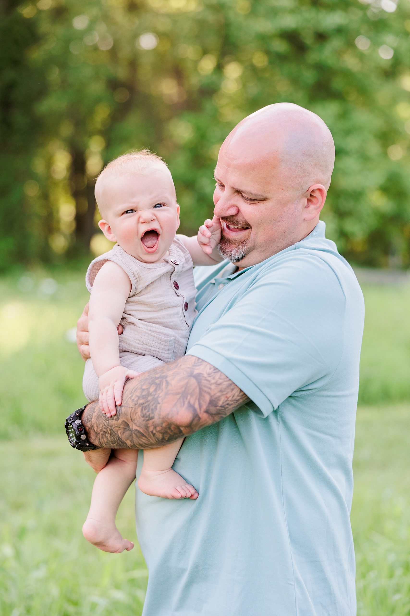 dad and son laugh together during Seneca Creek Park parenthood portraits in Maryland