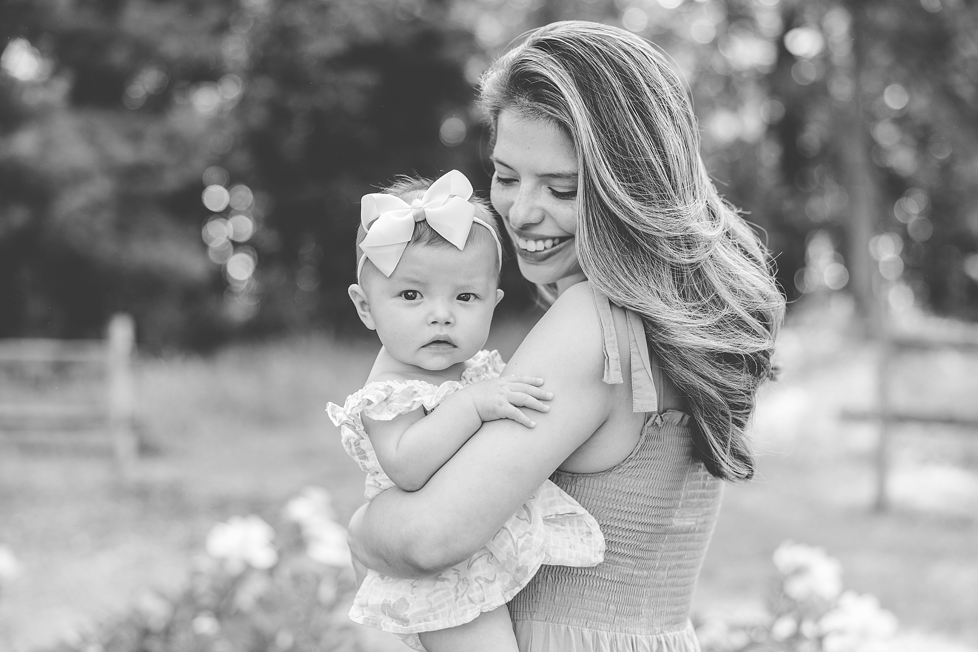 mom holds daughter on hip during Seneca Creek Park parenthood portraits 