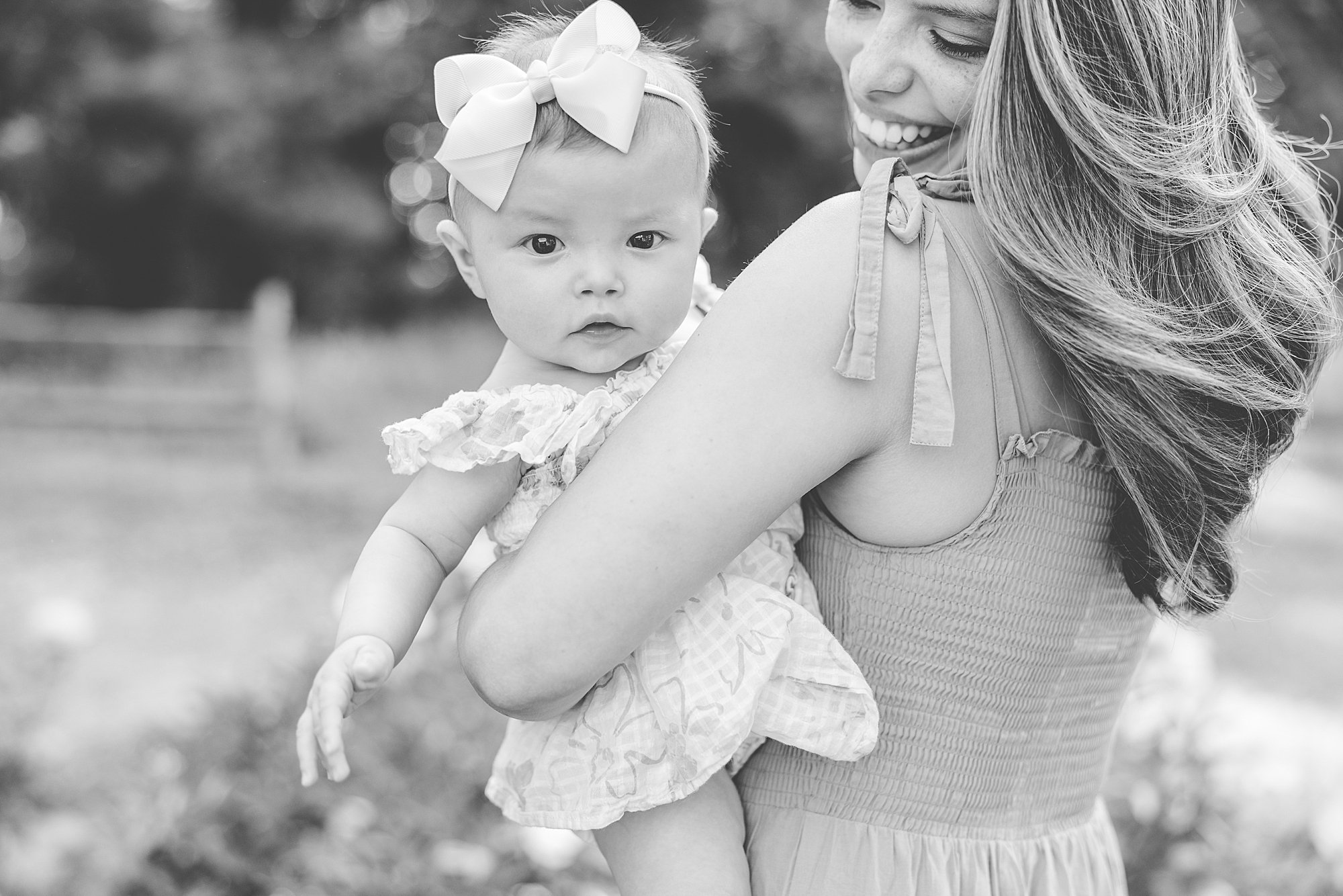 baby looks over mom's shoulder during photos in Gaithersburg MD