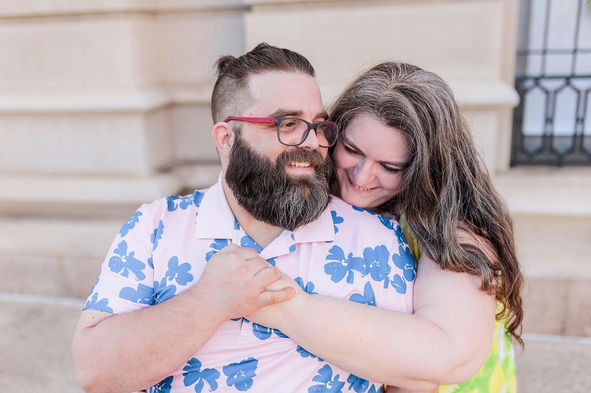 woman hugs husband from behind during Baltimore family portraits