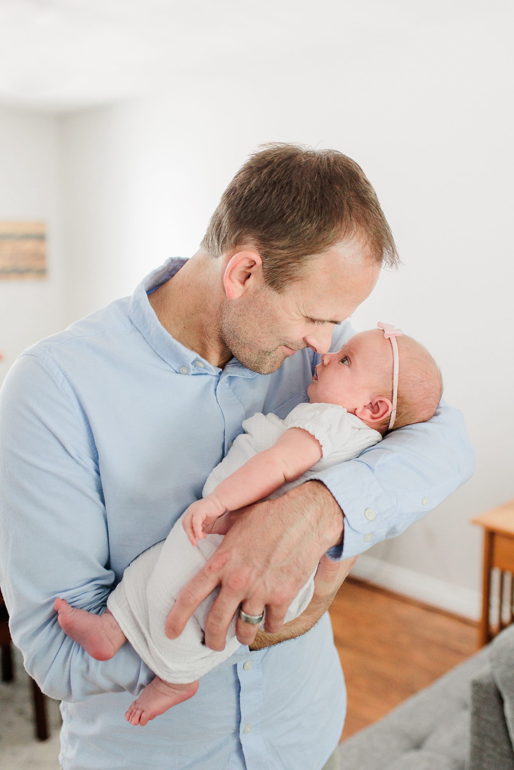dad nuzzles baby's nose during Annapolis MD lifestyle newborn session